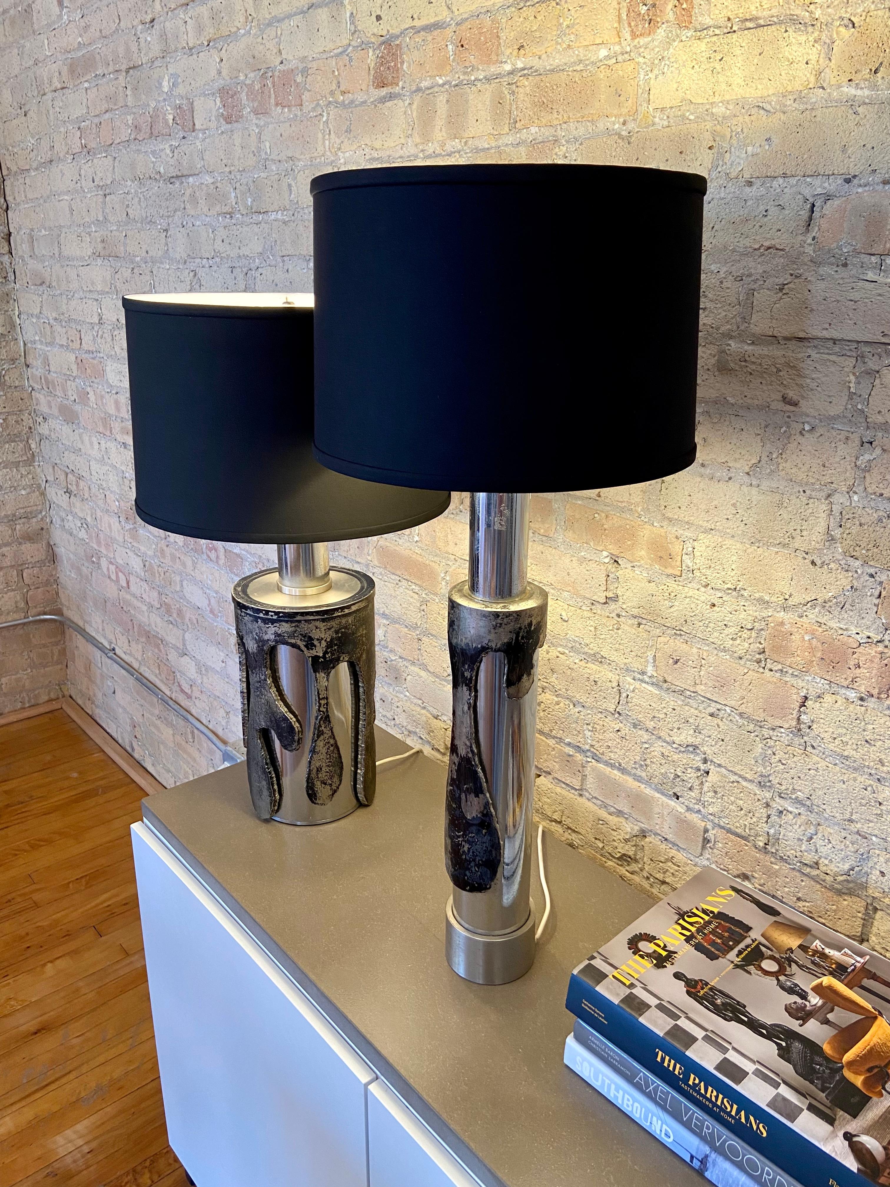 Pair of chrome metal table lamps designed by Marcello Fantoni

Tall Lamp: H: 27.5 in x W 4.3 in x D 4.3 in 
Short lamp: H 22 in x W 7 in 

Lamp shades included

Marcello Fantoni was a Florentine artist who specialized in ceramics. He studied