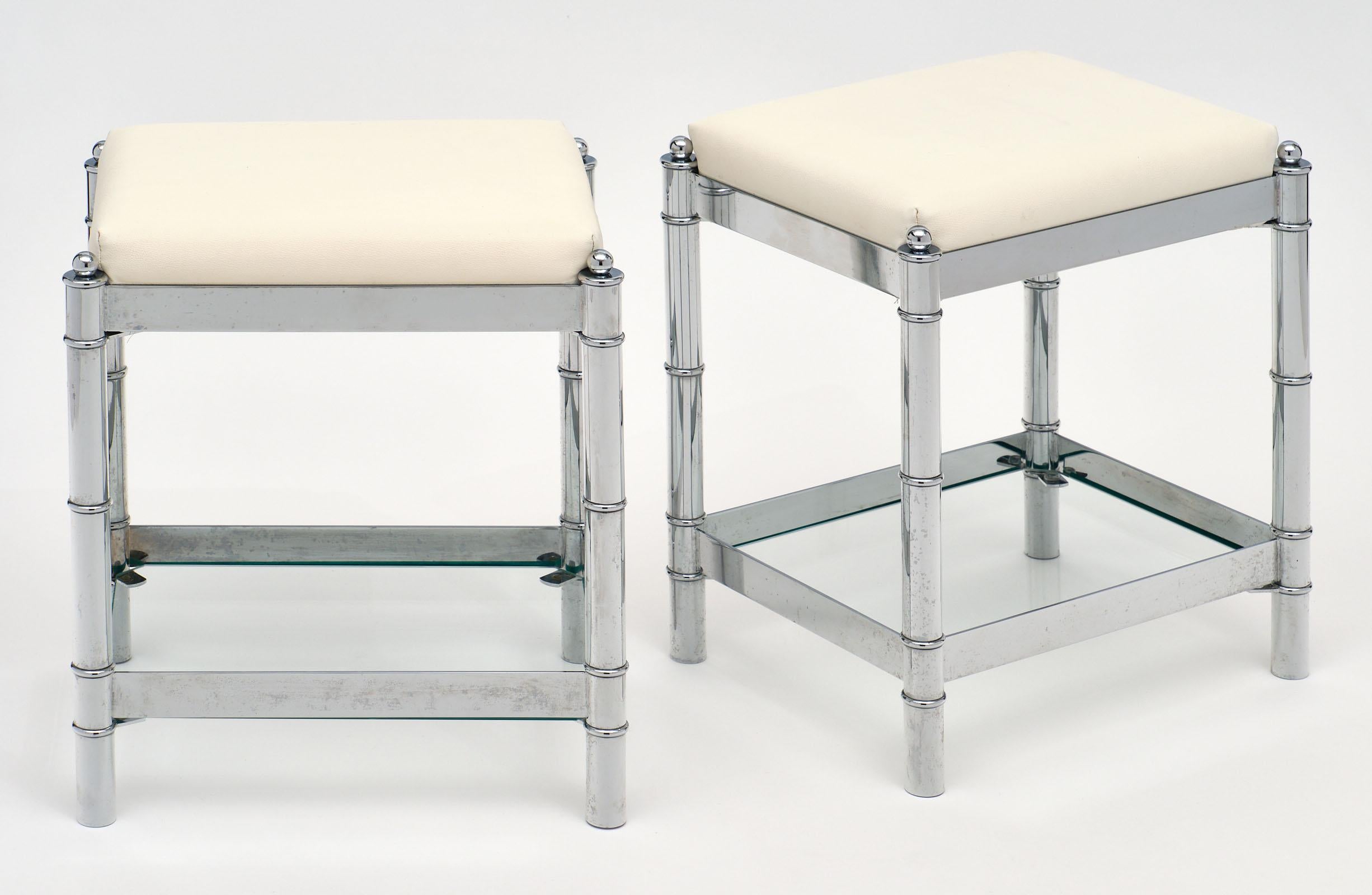 Pair of modernist chrome Italian stools with stylized bamboo chromed legs. Each stool features a clear glass lower tier for functionality. There are four of these stools available in all, priced per pair.