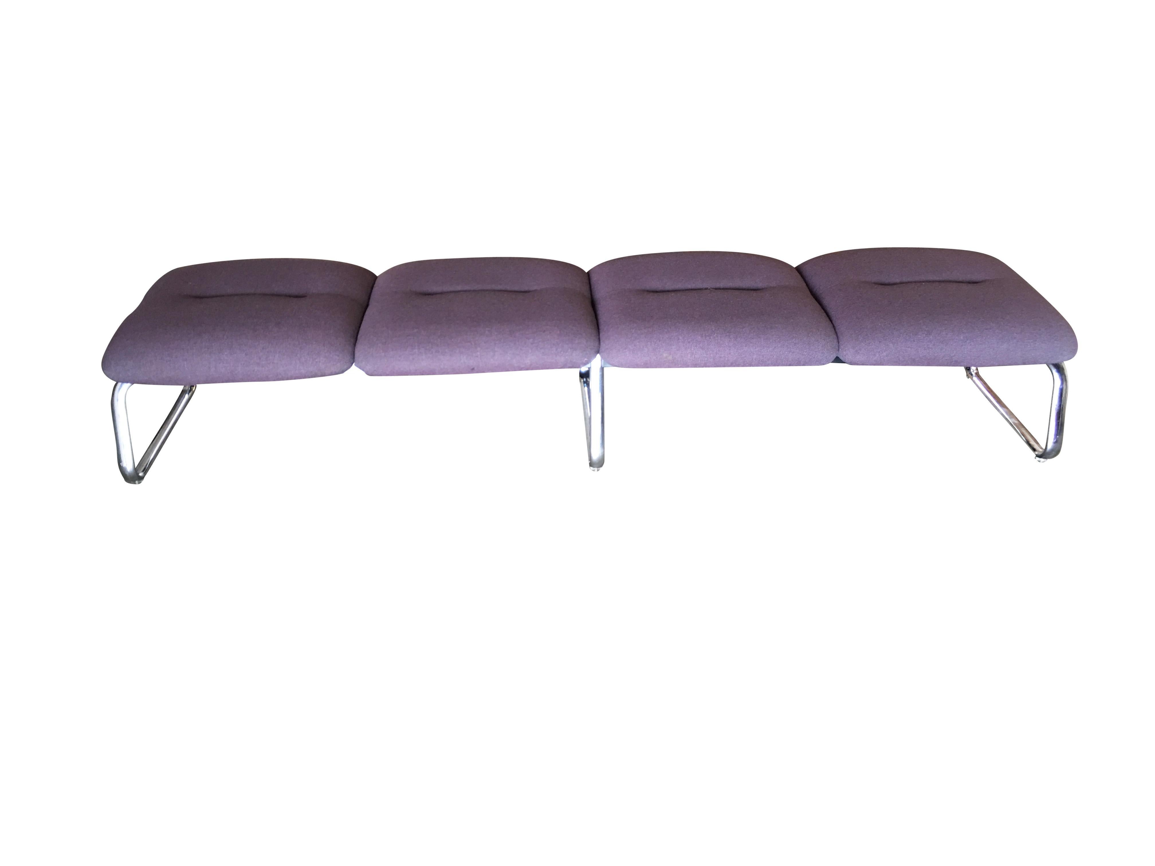 Chrome modernist waiting room bench featuring four purple-colored covered cushion seats fixed to 3-chrome loop style legs. Available- 2, circa 1970s.