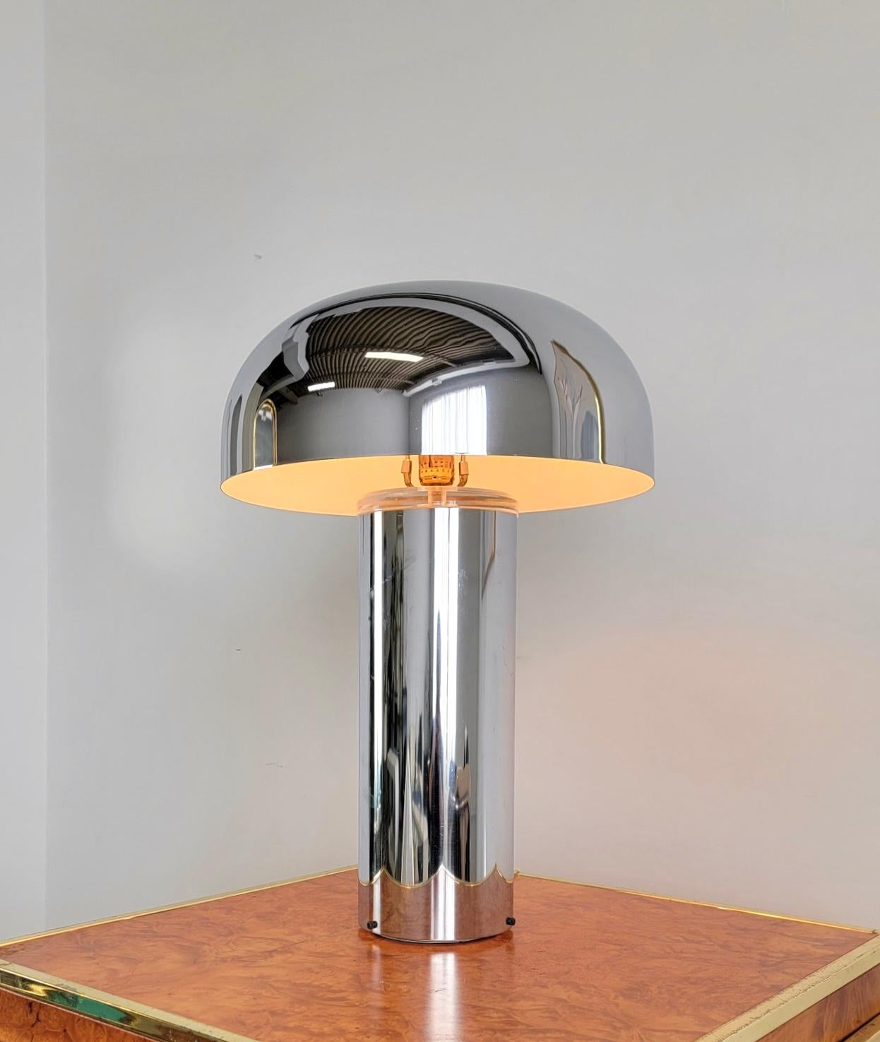 Stunning chrome table lamp from the 1970s. It features a chrome body and shade with a lucite accent on the lid of the body. The shade is in the shape of a dome. It resembles the style of Laurel mushroom lamps as well as      Franco Mirenzi lamps. In
