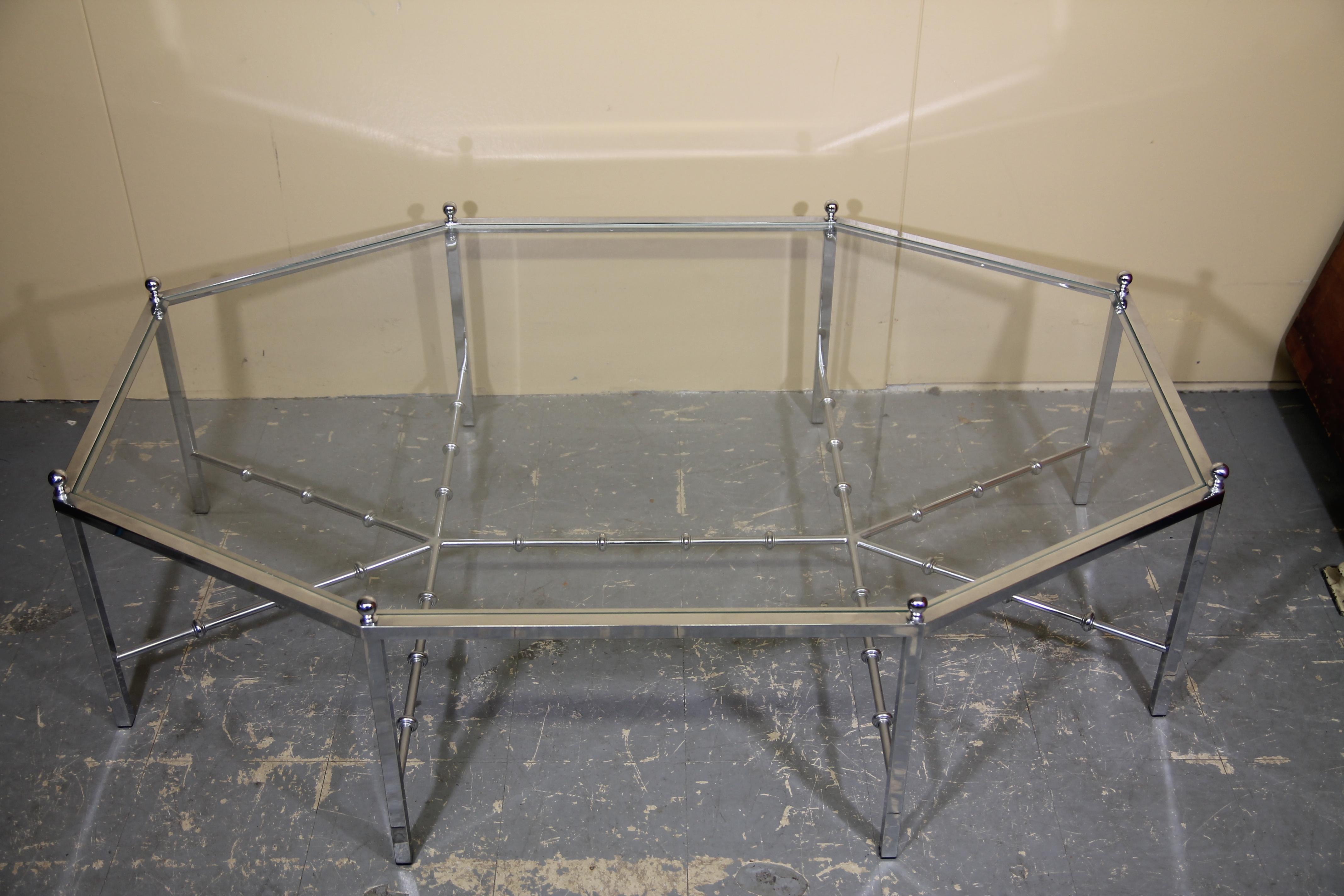 Wonderful oversized chrome coffee table by Maison Jansen. This neoclassical style table was produced in the 60s. Has great faux bamboo style stretcher on the base.