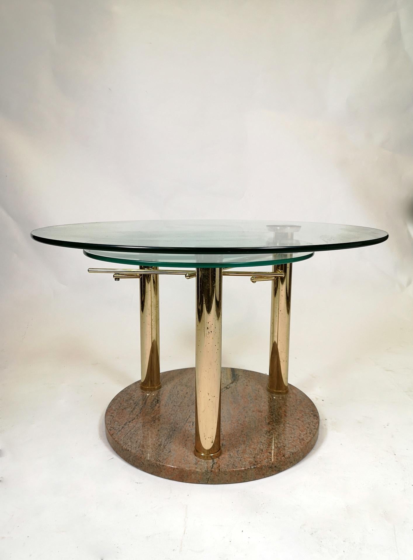 Chrome-plated adjustable glass coffee table with three shelves on a marble stand from circa 1970s.
You can adjust the bottom glass by rotate the one on the top.
It has some minor fading on the legs surface and on the glass.