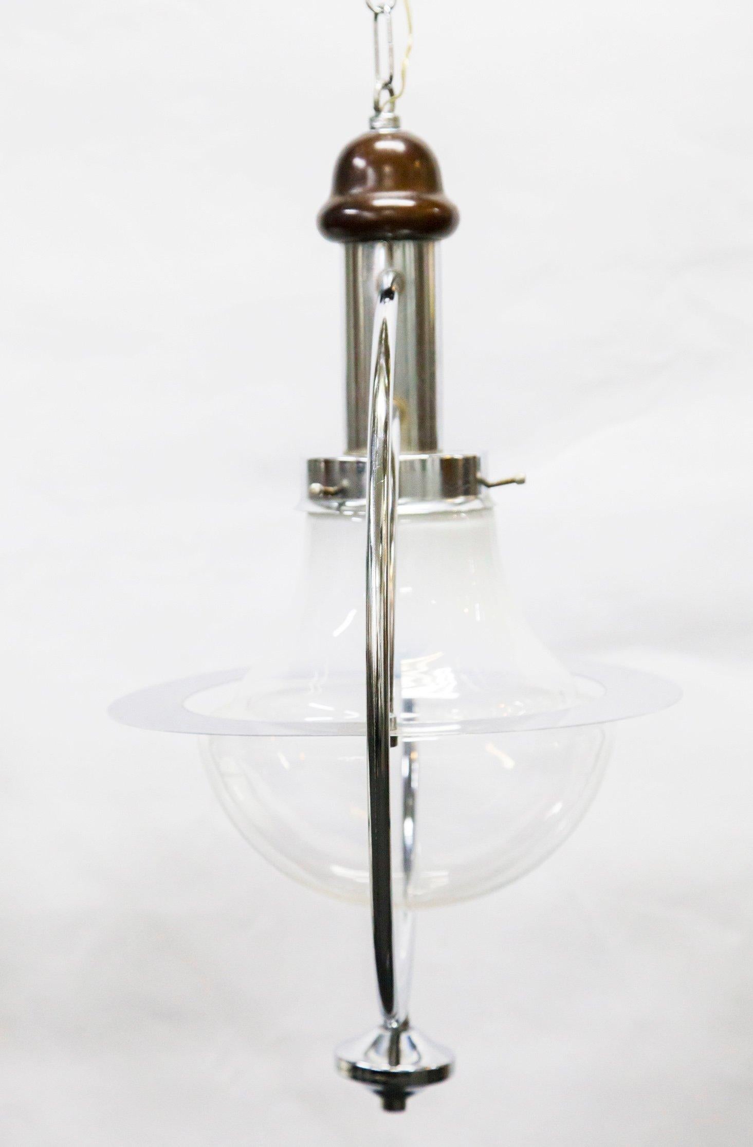 Chrome-plated glass pendant lamp, 1960s.
Murano-style handmade glass pendant lamp with chrome-plated body and wooden accents. Excellent condition.
This item has no defects, but it may show traces of use. Wear consistent with age and use.
 