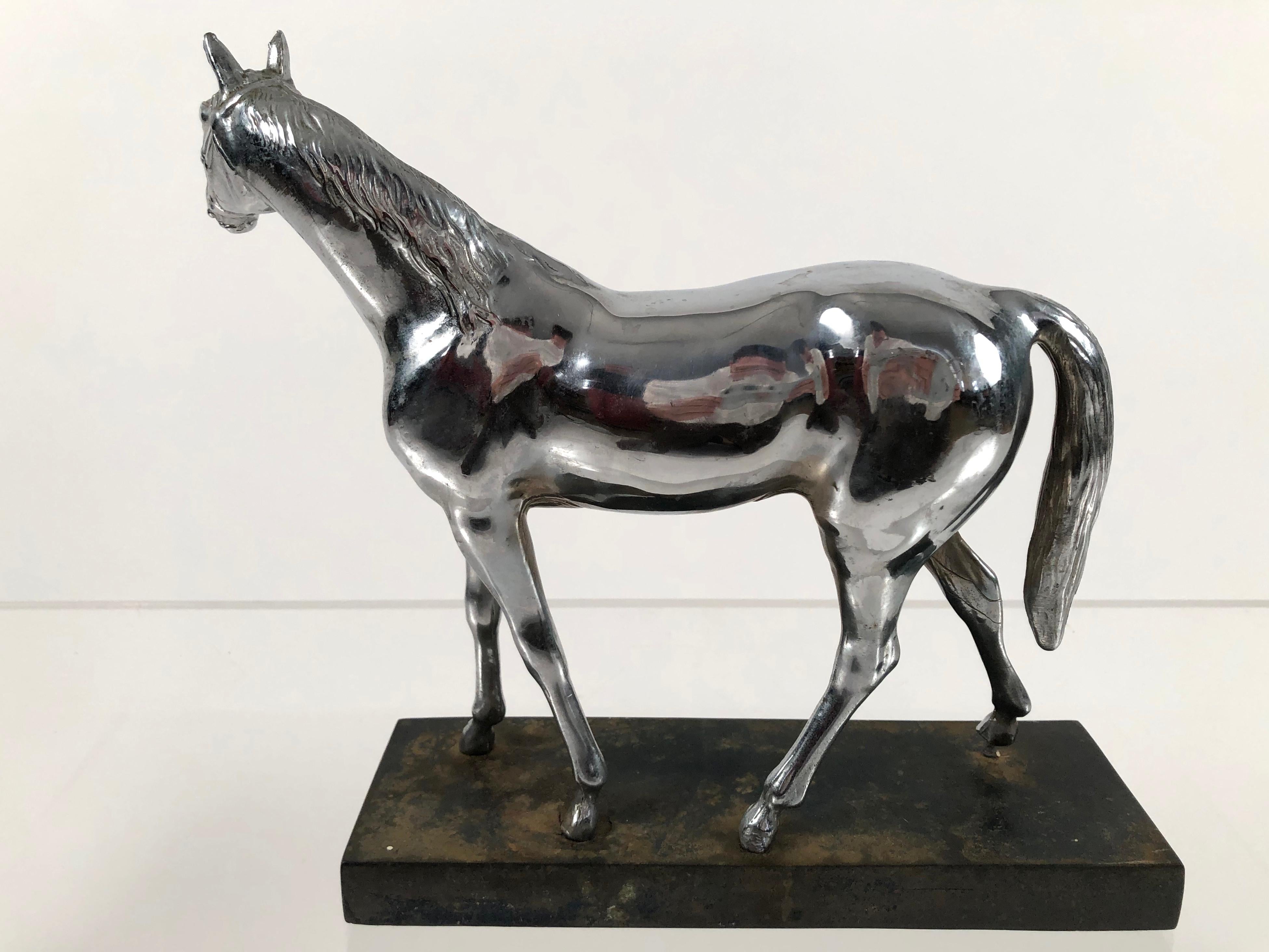 An unusual and decorative chrome-plated sculpture of an elegant horse, mounted on a metal plinth.