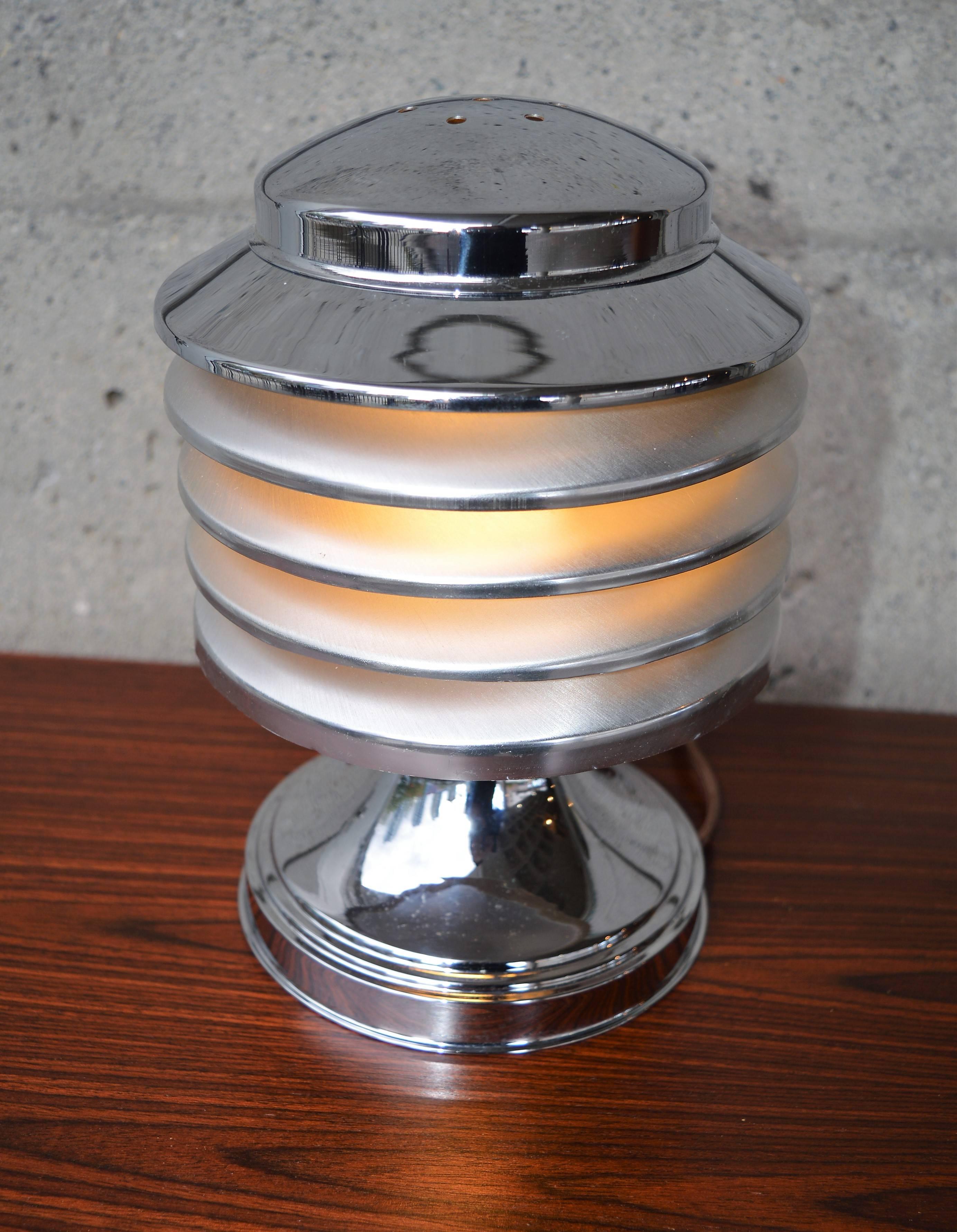 This striking table lamp was made by Coulter for Coulter Lamp (Toronto). It was manufactured, circa 1930. It is made of chromed metal and composed of five superposed discs. The top opens for bulb replacement and it is in amazing vintage condition.