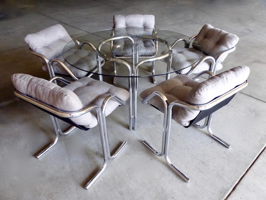 A six-piece chrome-plated tubular steel dining set designed by Jerry Johnson in the 1970s for his arcadia Line, made by the Landes Manufacturing company. The set comprises the table and 5 chairs. The chairs are a sling design with removable back and