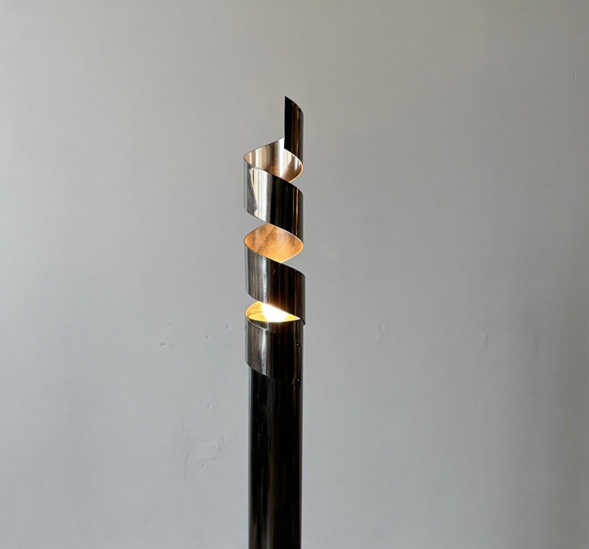 The Chrome-Pole Floor Lamp from Italy, crafted in the 1970s, is a striking example of timeless design and functionality. Its sleek chrome finish exudes sophistication, making it a perfect addition to any modern or midcentury-inspired interior. The