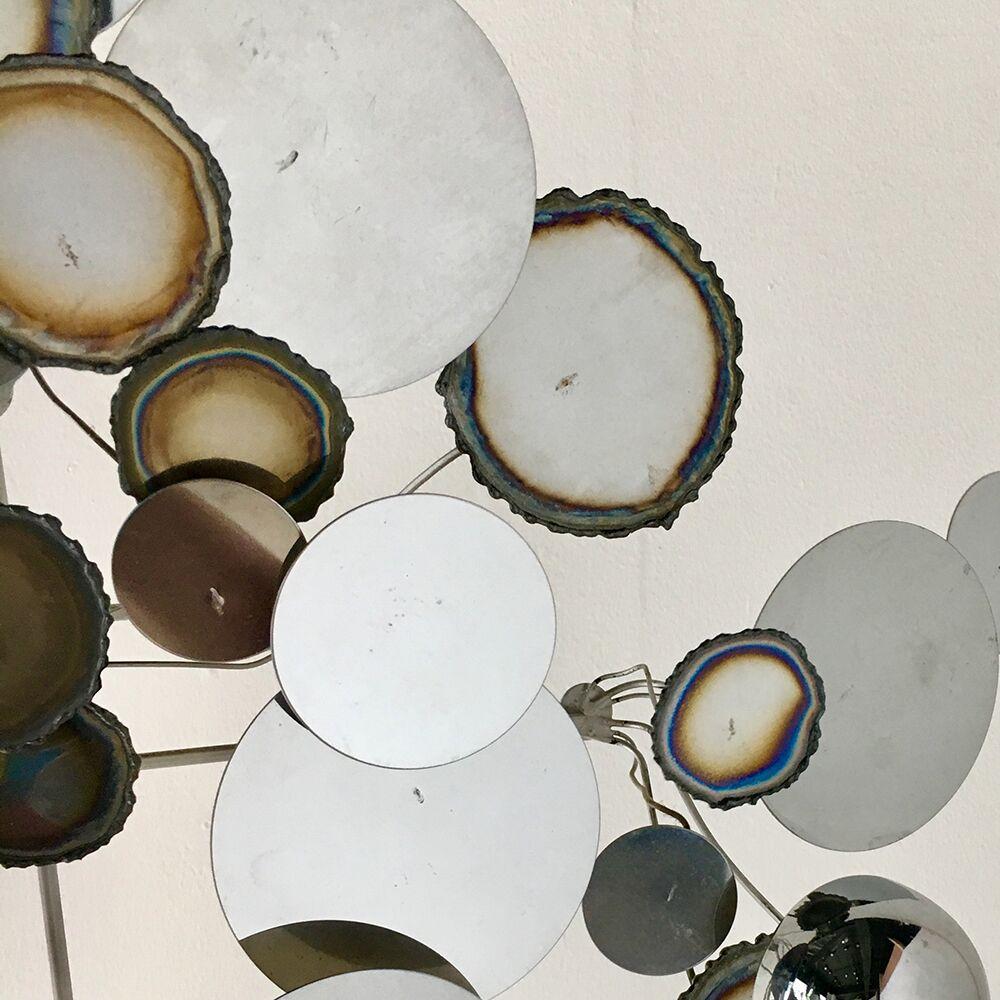 Chrome raindrops wall sculpture in the manner of Curtis Jere, 1980s. 
The circular discs of chrome have a great patina and the sculpture can be hung either vertically or horizontally.