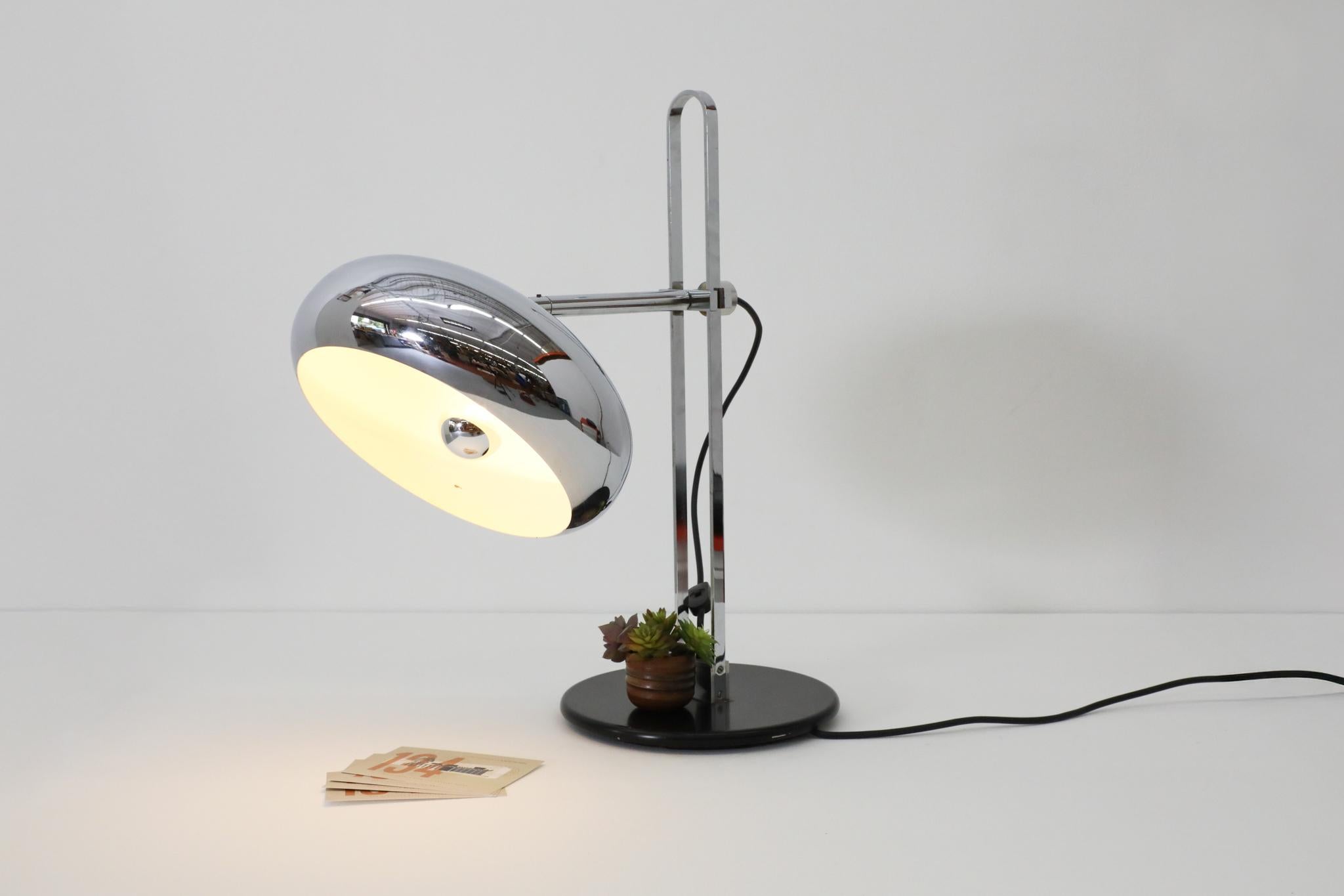 Large Van Doorn Verlichting chrome table lamp with domed chrome shade. Sleek and heavy table lamp with height and directional adjustable shade on a unique arch stem and black metal base. In original condition with some visible wear consistent with
