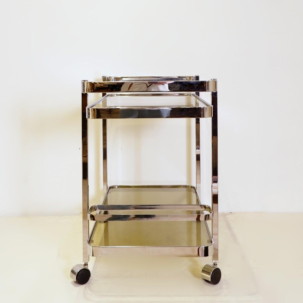 Smoked Glass Chrome rolling trolley with smoked glass tops, 70s, with bottle holder For Sale