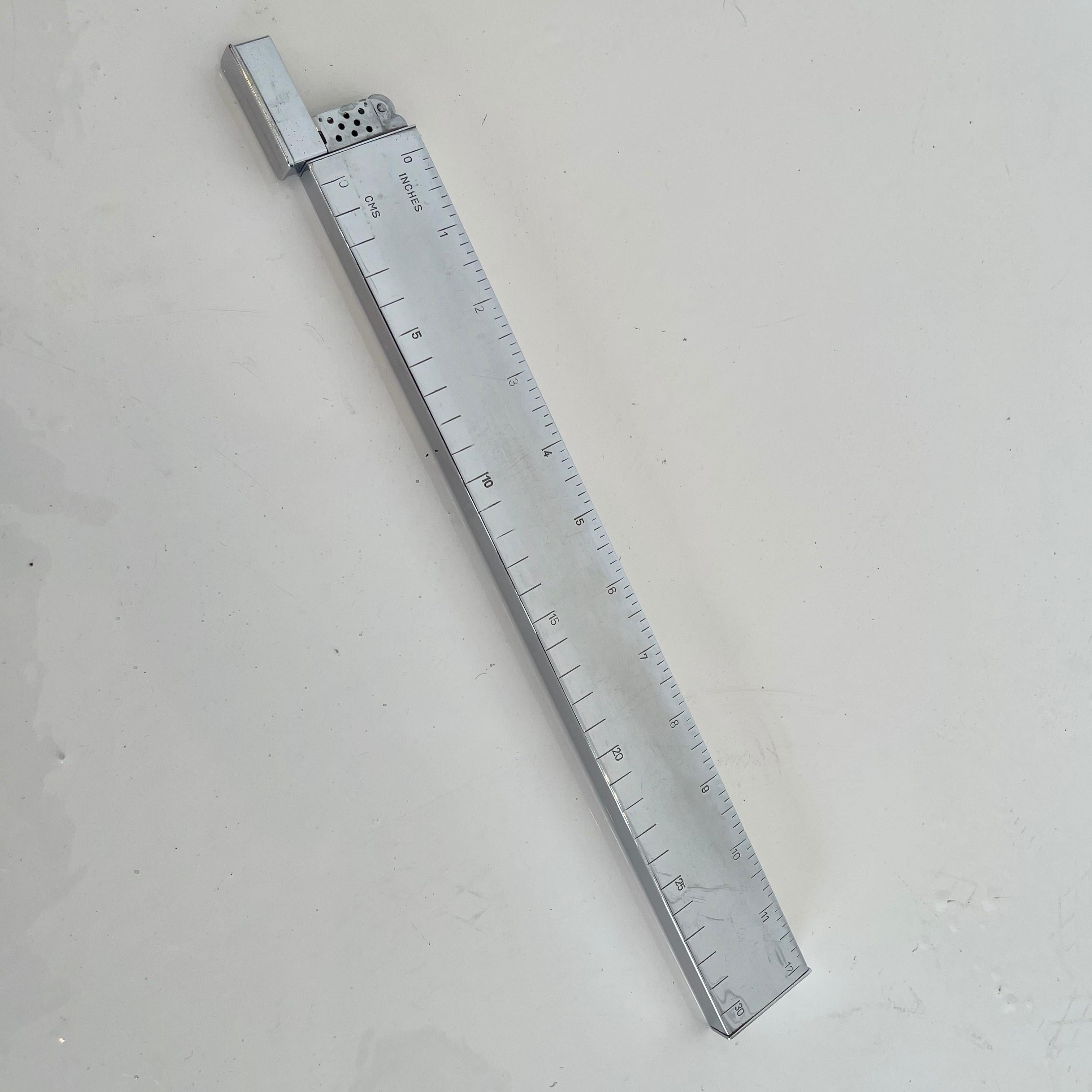 Cool vintage chrome 1 foot ruler with hidden lighter. Functional ruler and functional lighter with spark and flame. Fun conversation piece and tabletop object. Good vintage condition.