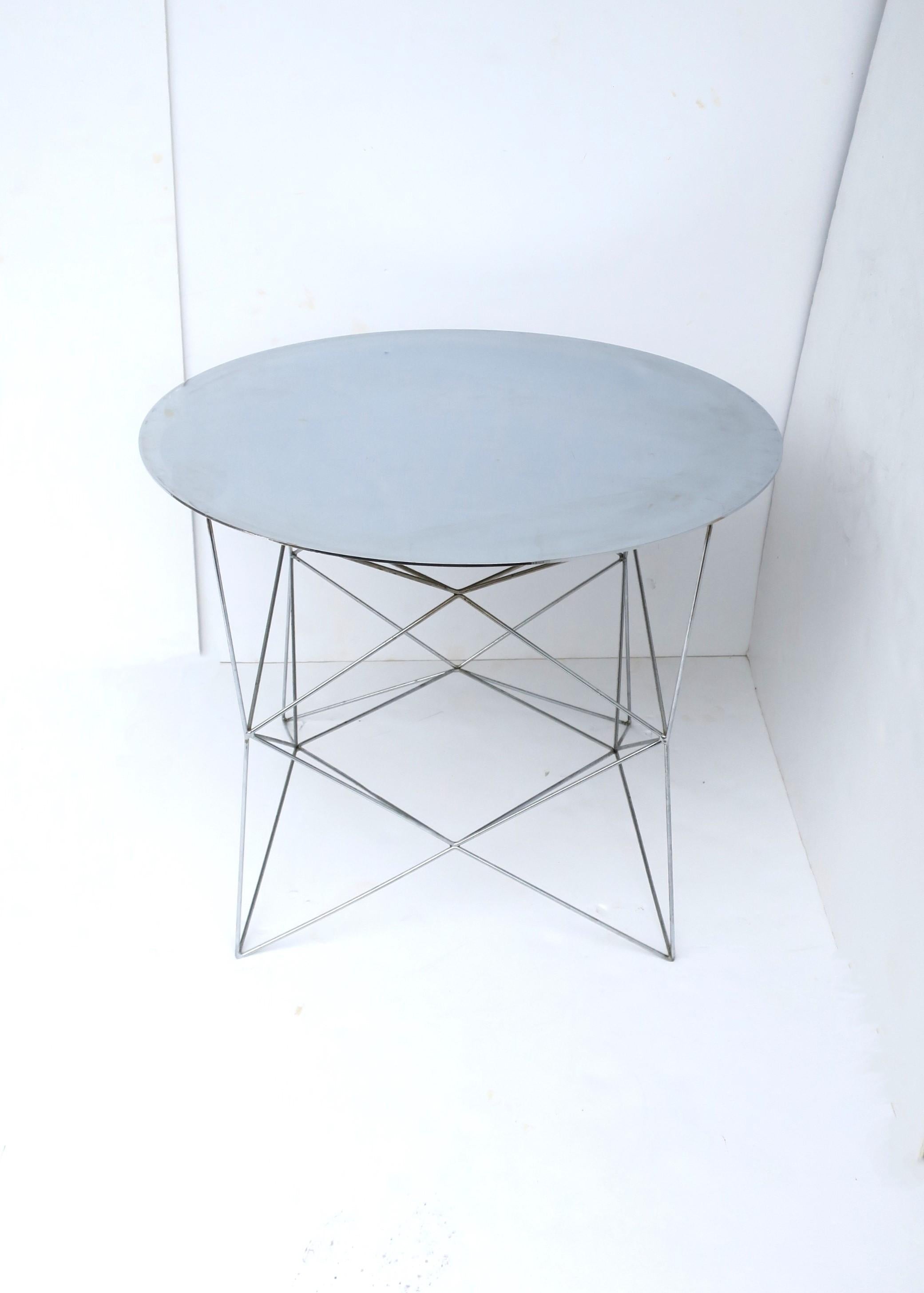 A nickel-plated chrome round side or end table with geometric chrome base, circa early 21st century. Tables' top is a beautiful, nickel-plated chrome with a geometric chrome base. A great piece for a living room, next to a sofa, chair, etc. Very