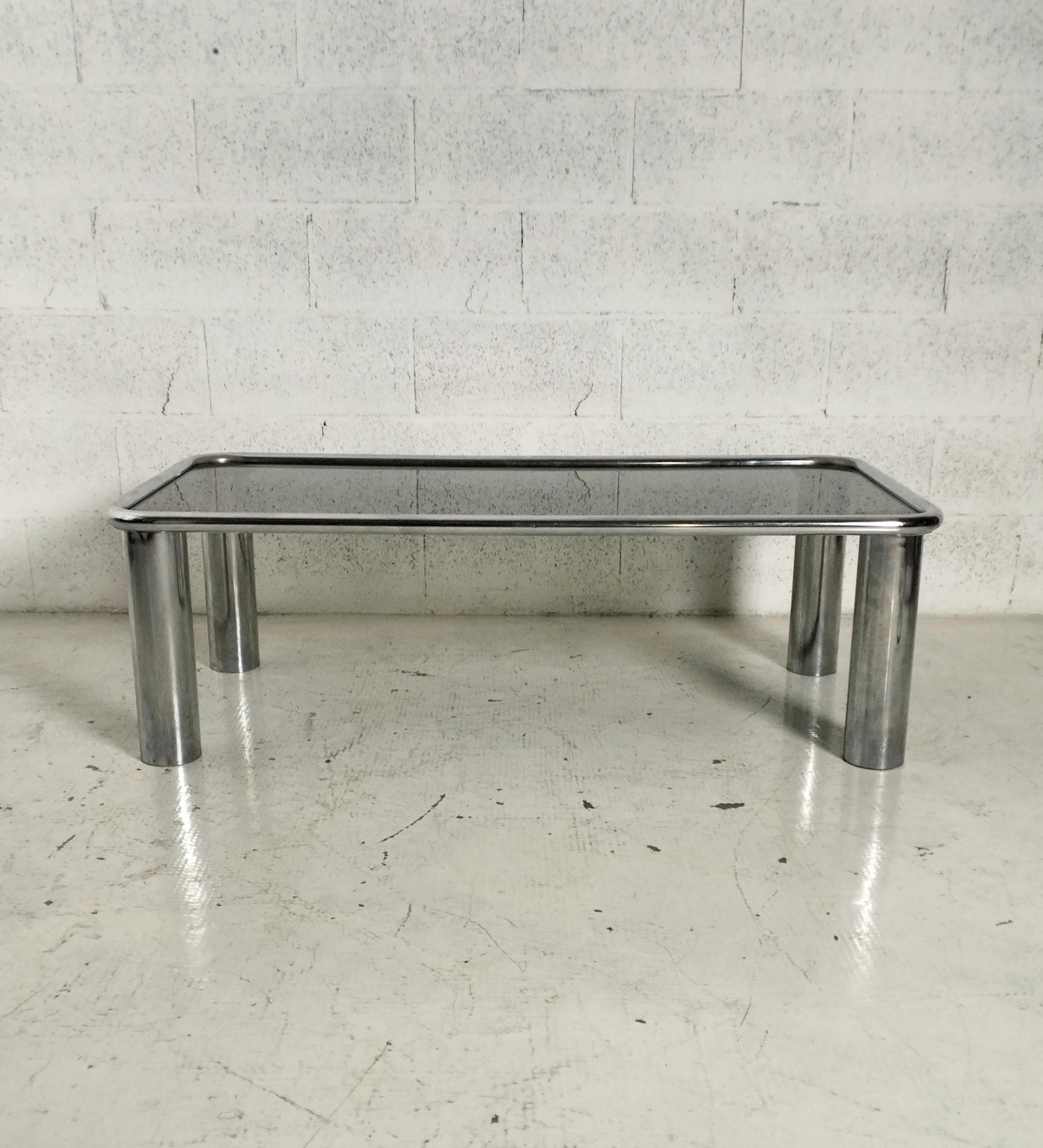 Stunning coffee table Sesann model designed by Gianfranco Frattini and produced by Cassina 1970s.
Steel chromed frame, smoked glass top.
This coffee table is a unique piece as it is part of the 