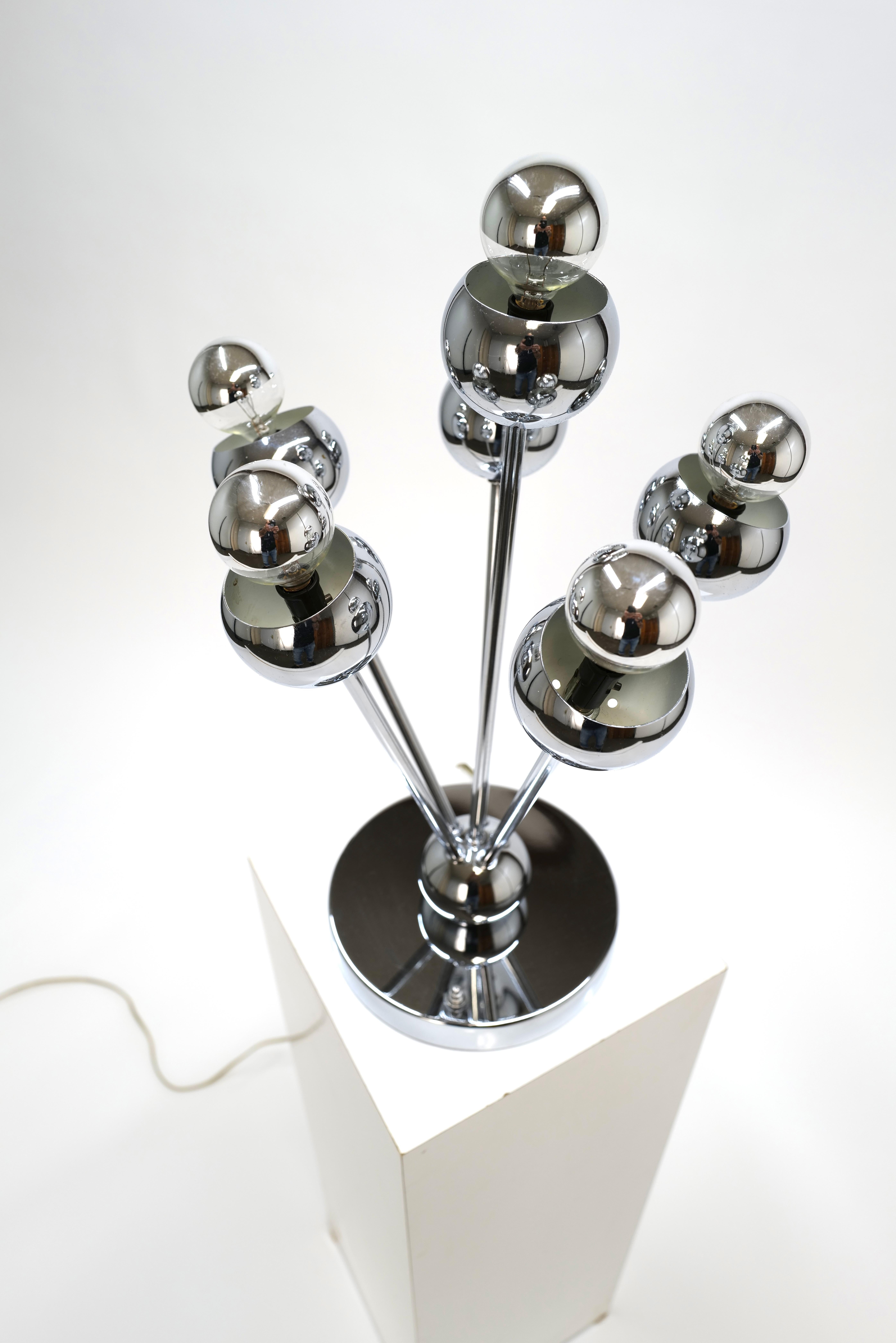The Chrome Five Head Sputnik Table Lamp by Torino combines futuristic design with functional lighting. With its sleek chrome finish and distinctive five-head configuration resembling the iconic Sputnik satellite, this lamp adds a touch of modern
