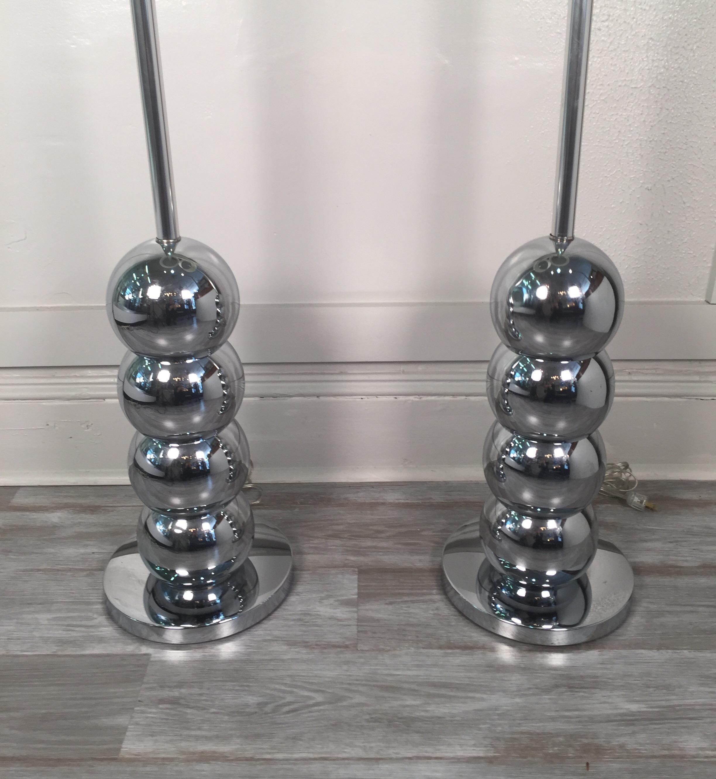 A pair of floor lamps in the manner of George Kovacs, four stacked chrome spheres support the body of the lamps. Shades are not included and shown for photographic purposes only.
