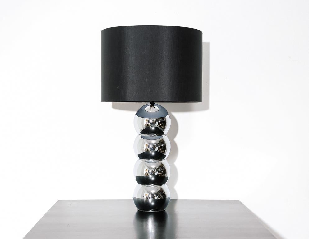 Vintage table lamp in the manner of George Kovacs. Chrome base with black drum shade.
