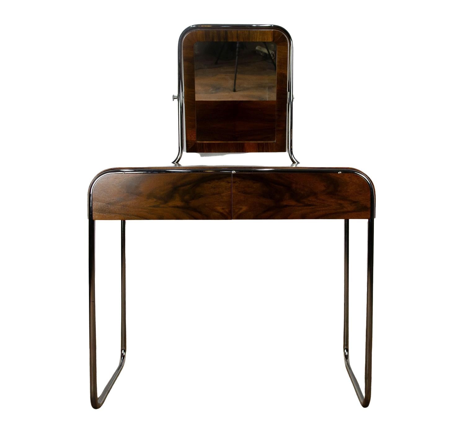 A minimalistic walnut veneered dressing table on a chrome-plated Bauhaus - style structure referring to German Bauhaus.
An extraordinary thing, one of a kind, was created only in a few pieces.
It has two functional compartments and two slim, flat