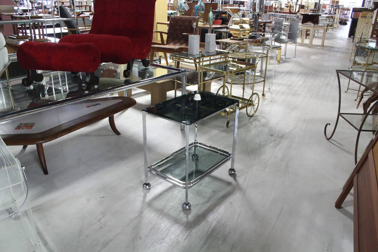 Italian Mid Century modern chrome bade glass top cart with concealed wheels.