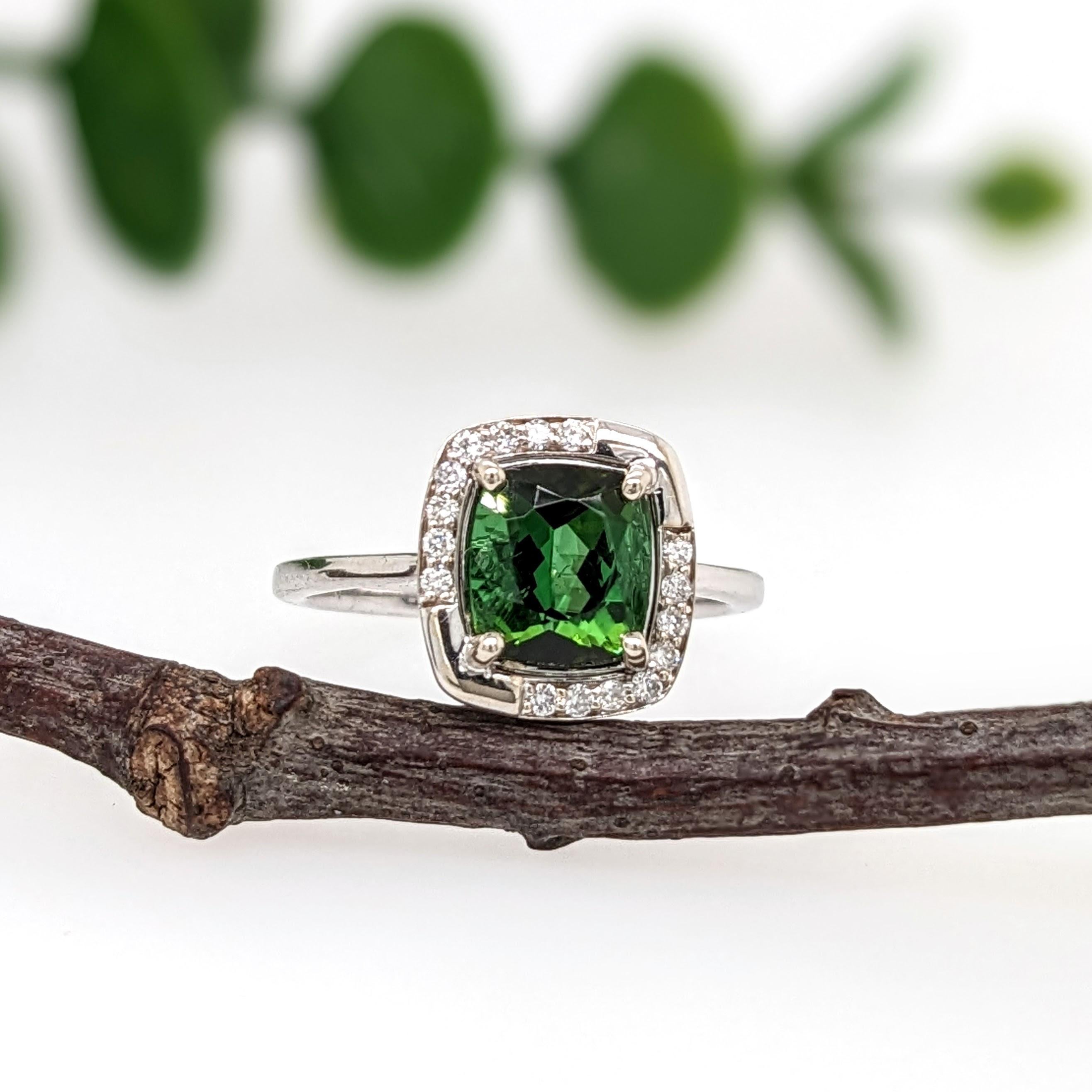 A vivid chrome tourmaline looks exquisite in this elegant ring with a diamond halo. A statement ring design perfect for an eye catching engagement or anniversary. This ring also makes a beautiful October birthstone ring for your loved