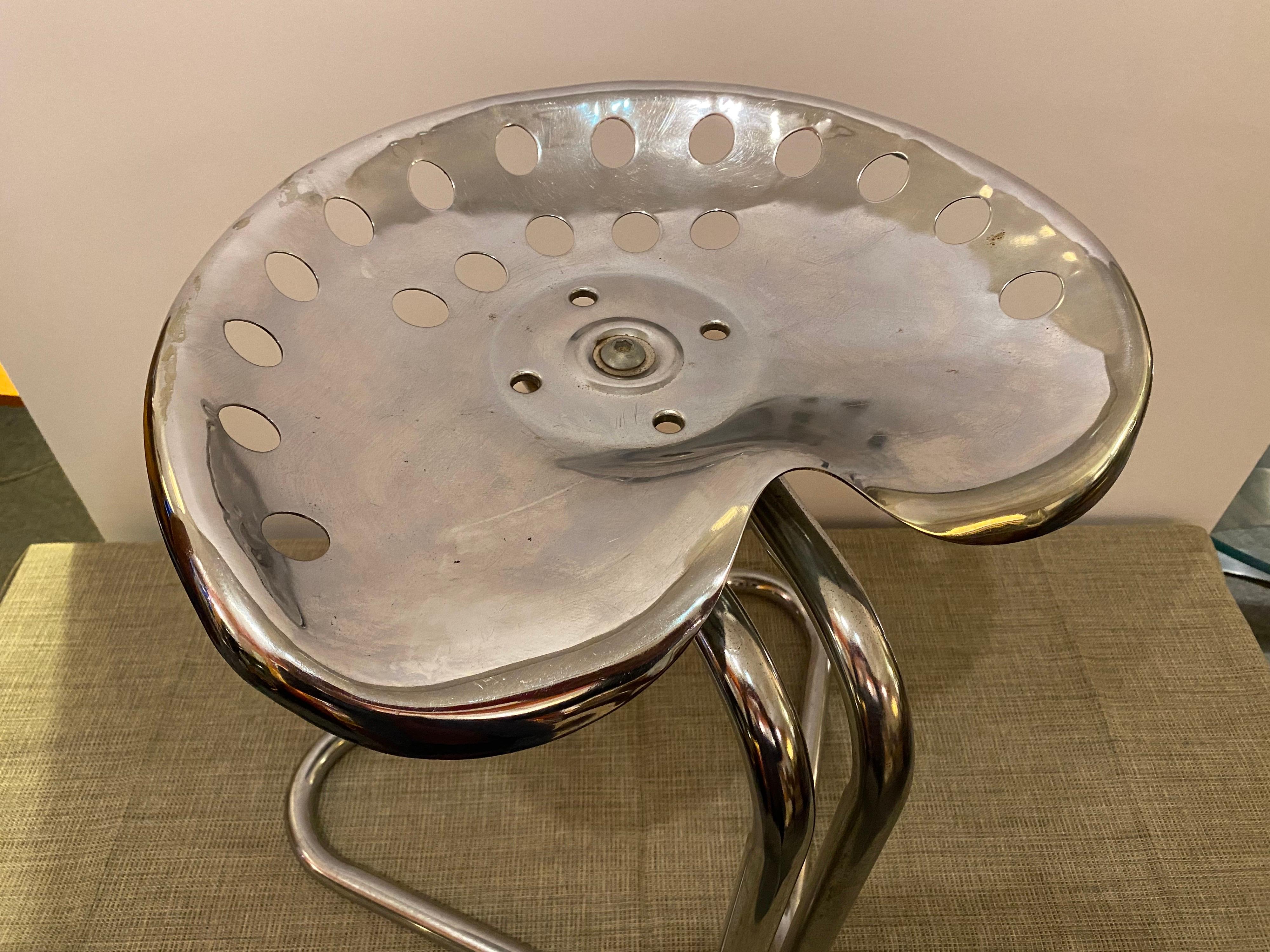 Chrome tractor stool in the style of Achille and Pier Giacomo Castiglioni. Stool dates the 1970's. Shows signs of use and wear, overall Chrome presents pretty well. Nice design, fits easily into many spaces and uses.