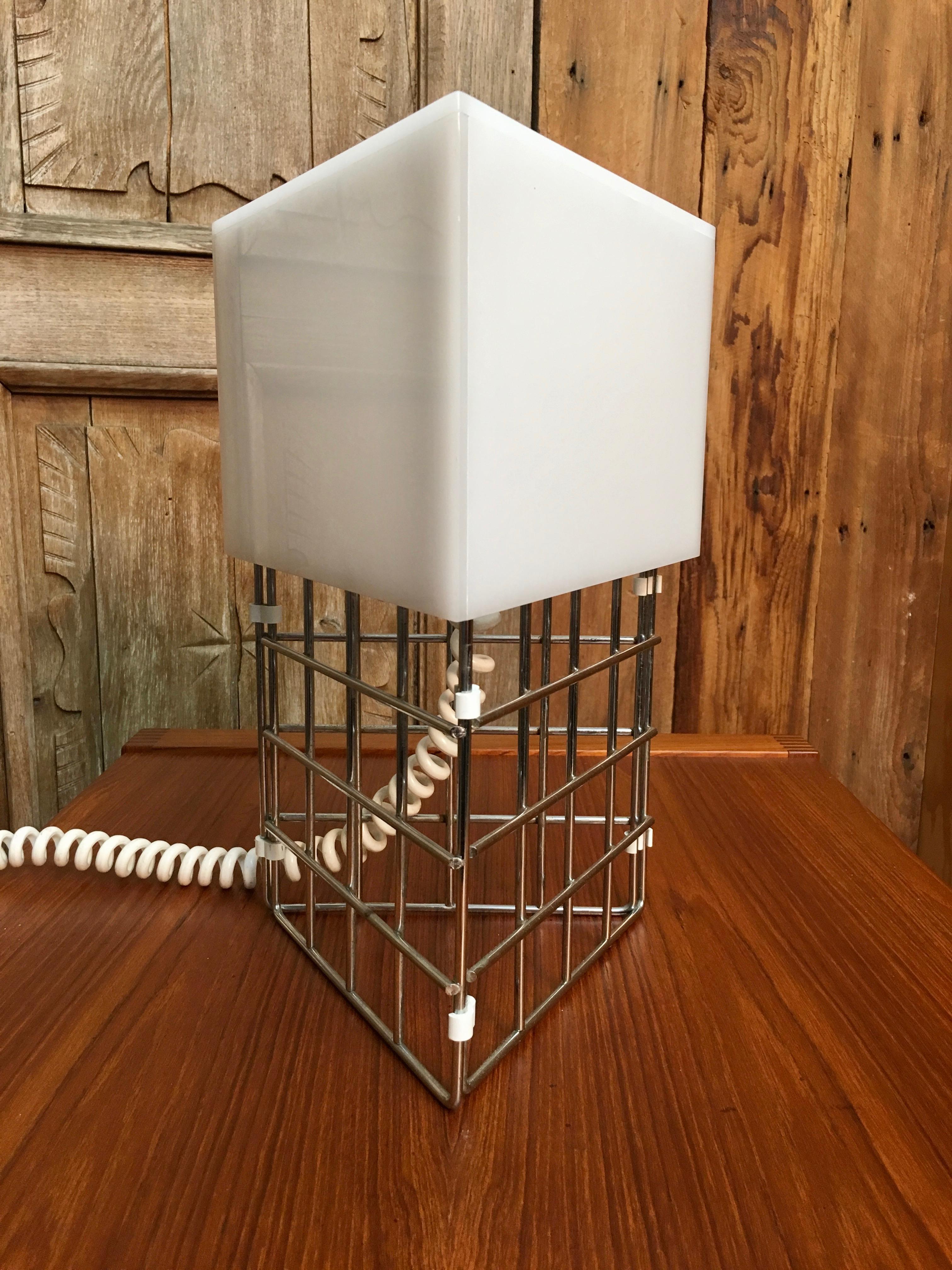 White Lucite with chrome geometric chrome base and original pigtail phone power cord.