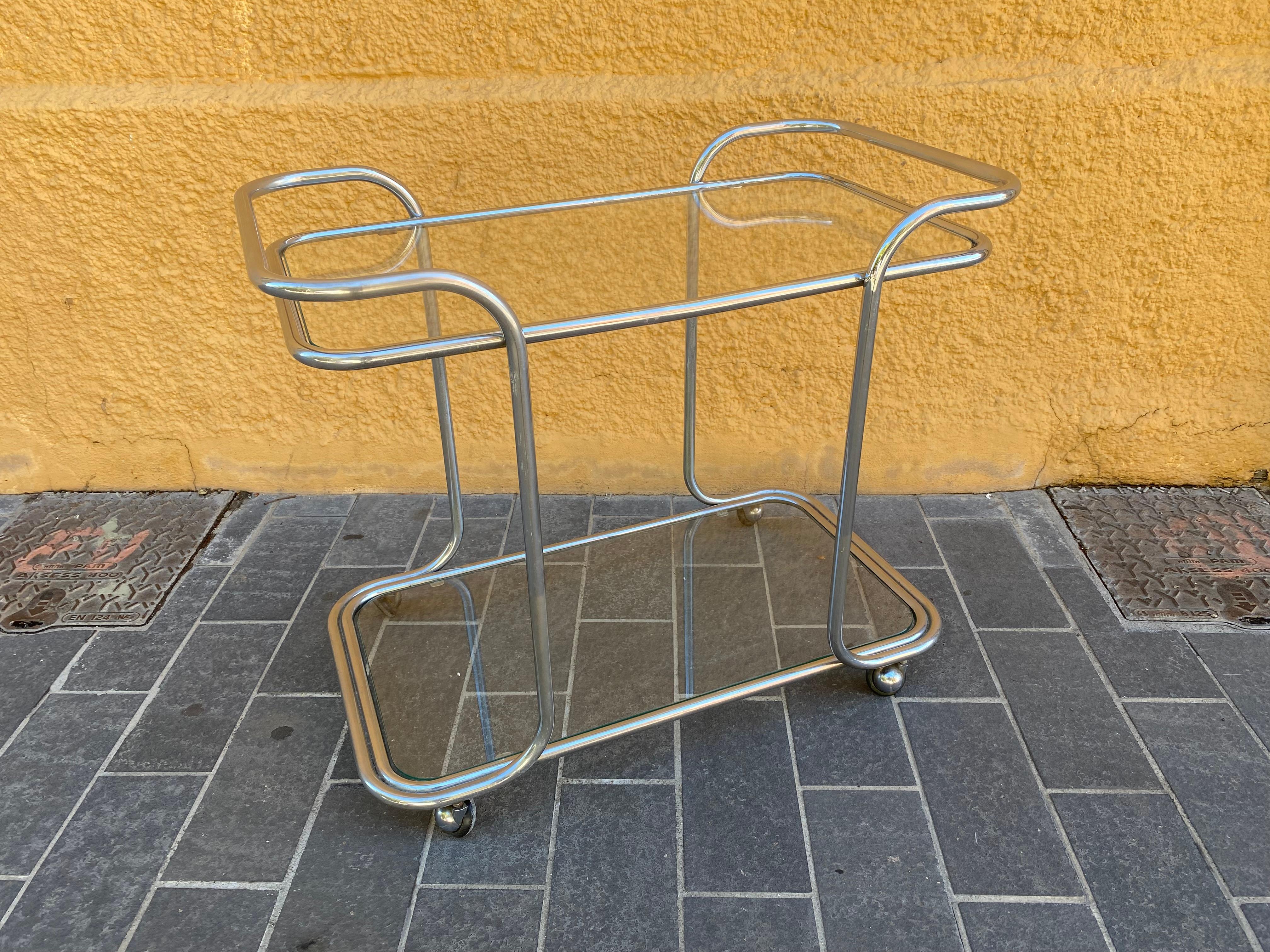 chrome metal trolley with two clear glass trays. Origin Italy, period 1970. In good condition
