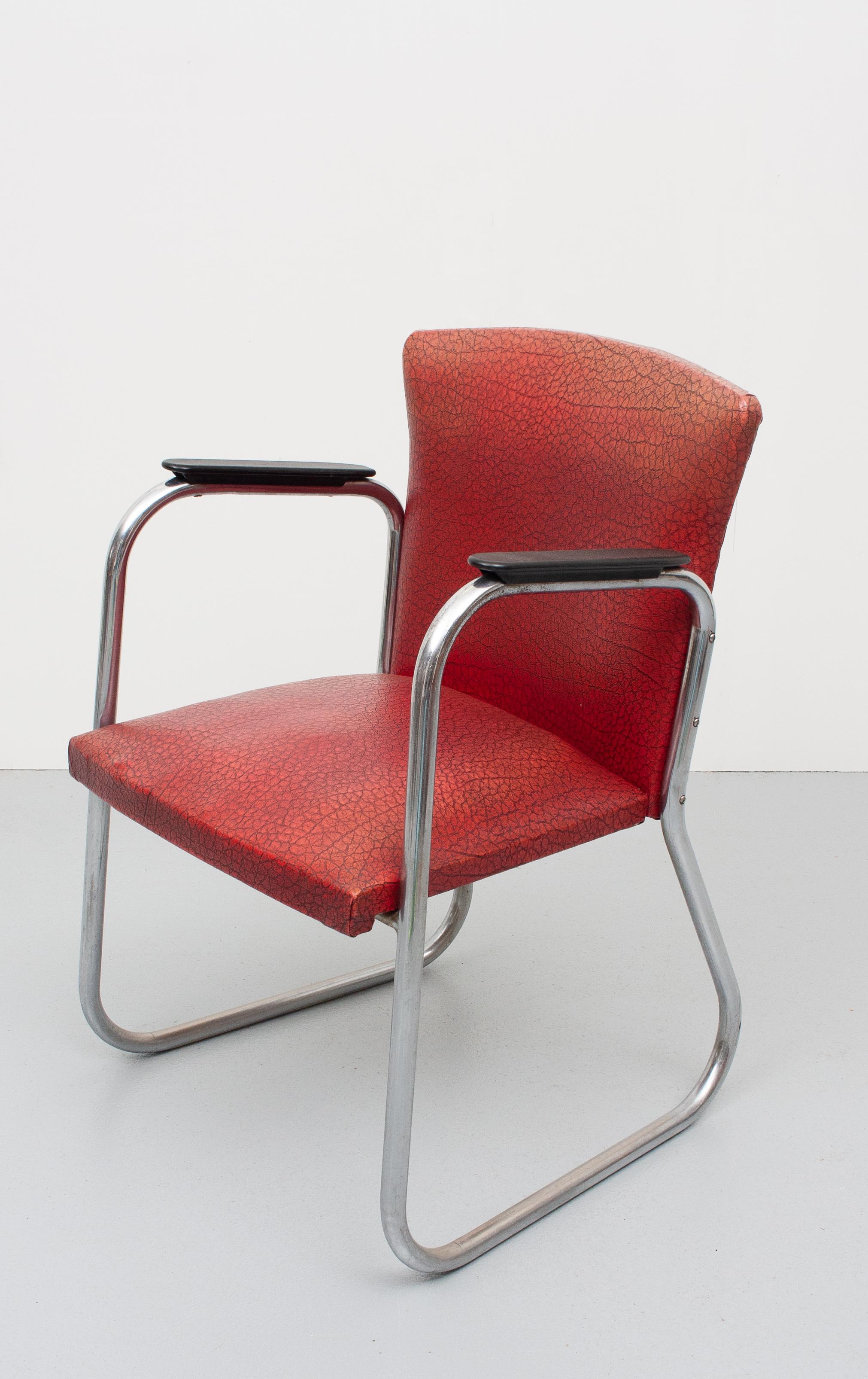 Very nice desk chair. Chrome tube frame, comes with the original red faux Leather upholstery.
Bakelite armrests. 1950s Holland.