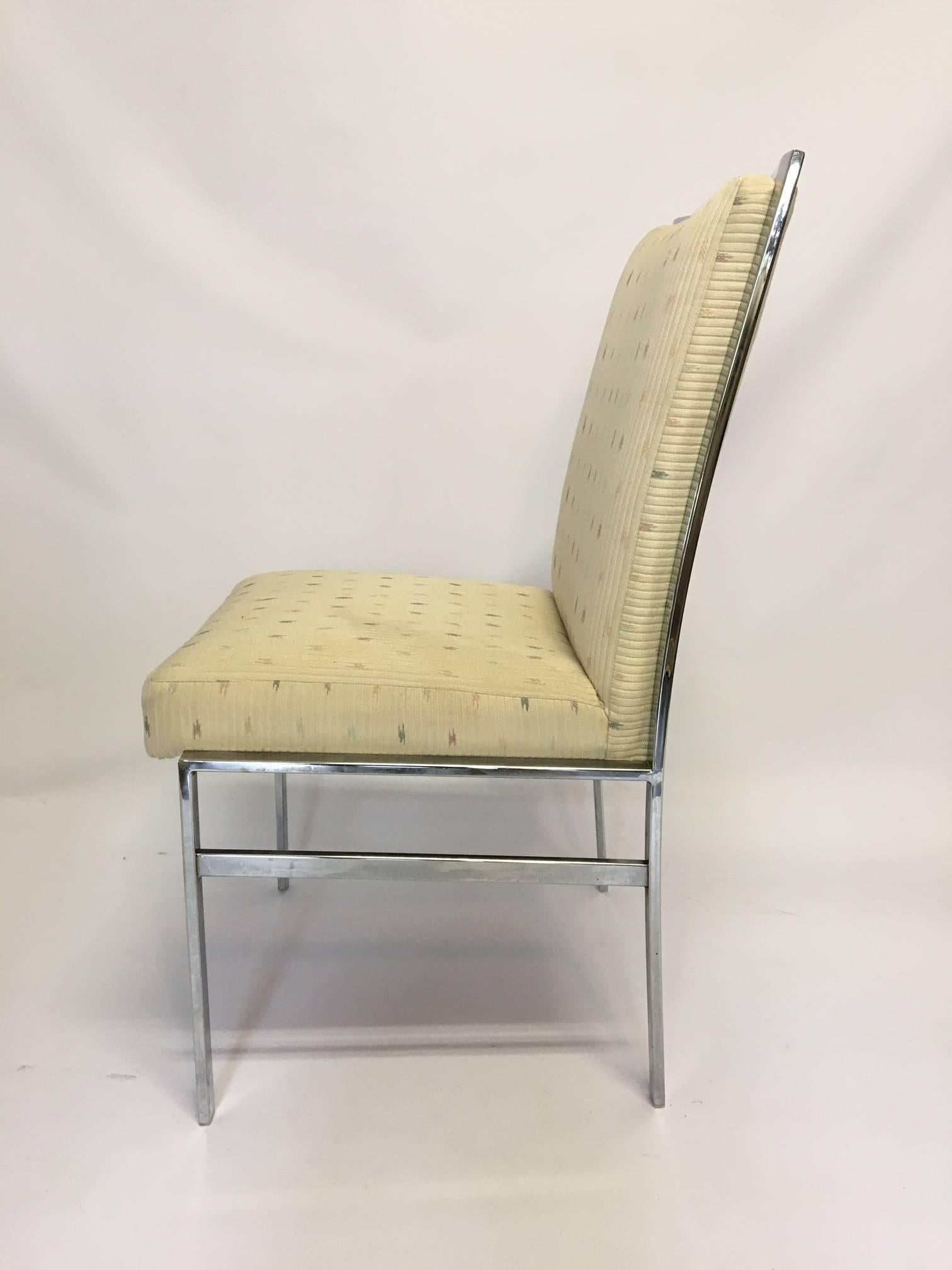 Chrome dining chairs upholstered in a light tan heavyweight fabric. Chrome finish is in excellent vintage condition. Fabric has some areas of discoloration. Measures: Seat height is 19