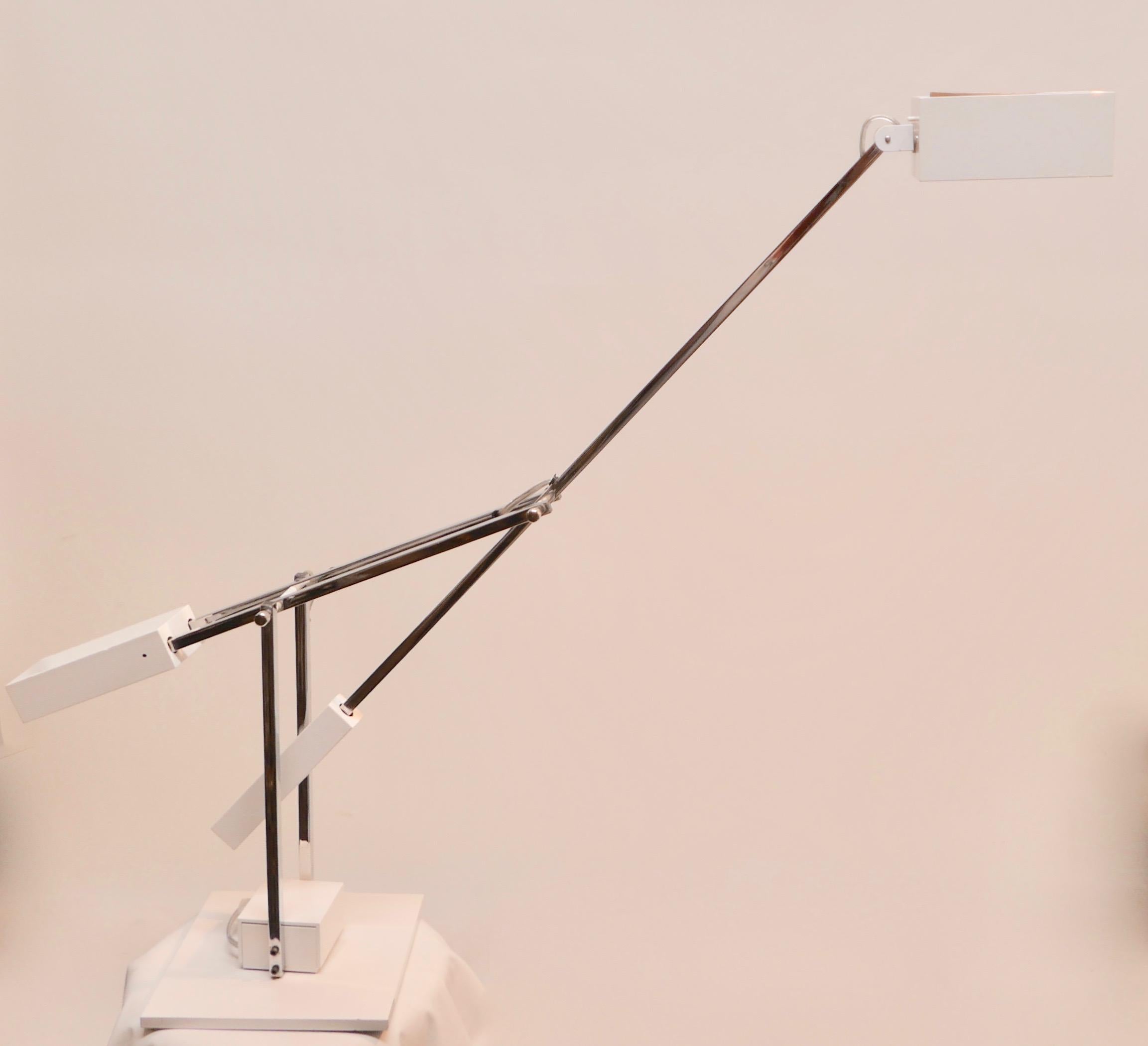 A beautiful Mid-Century Modern / Minimalist articulating chrome & white metal desk lamp designed by Robert Sonneman. The counter balanced light, controlled by a dimmer switch at the base, also swivels and turns and is attached to a second counter