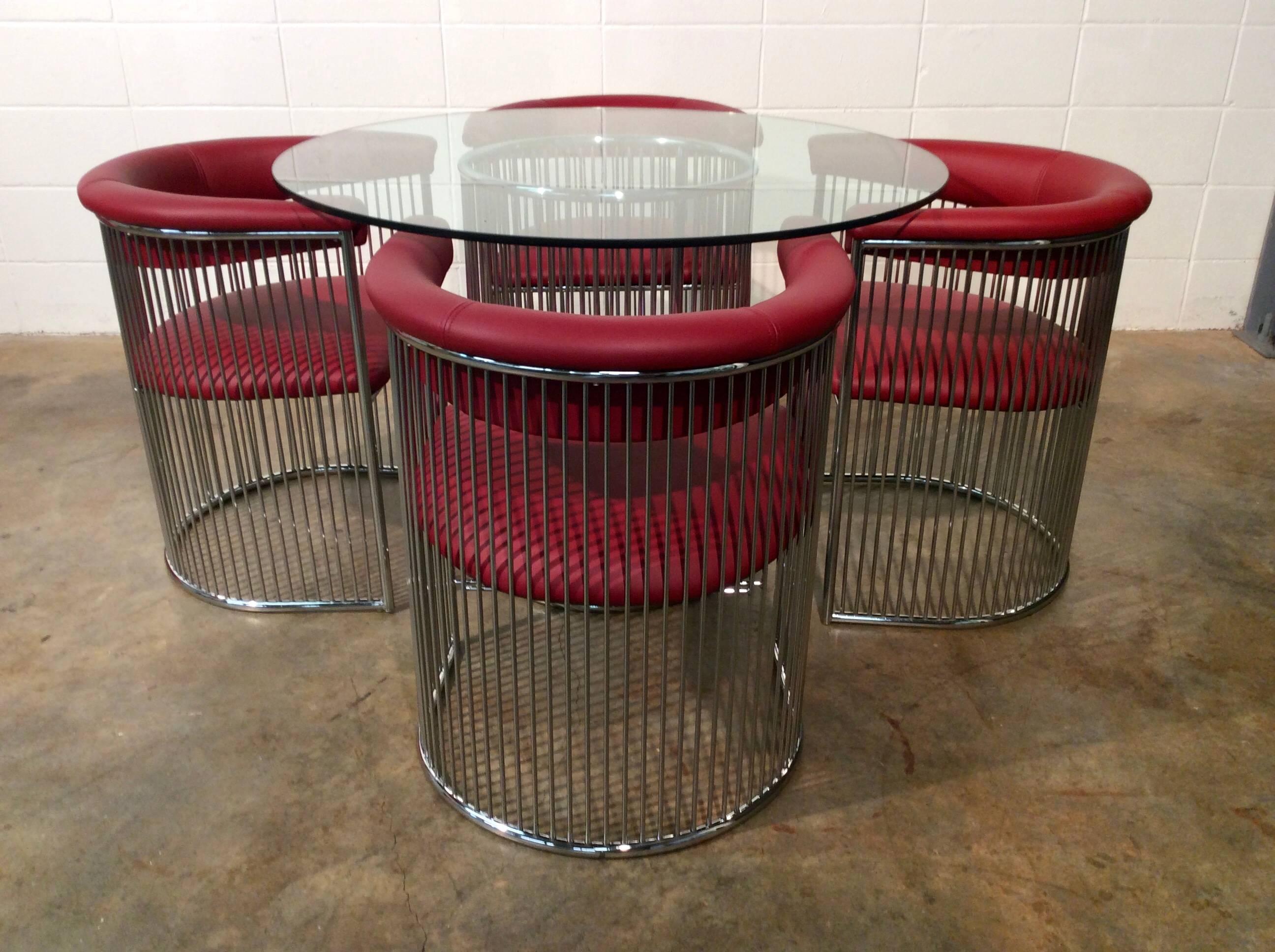Chrome wire dining set designed by Arthur Umanoff for Contemporary Shells Inc.

 Amazing chrome wire base topped with heavy glass and circled by four Chrome wire chairs that are upholstered in Red Italian Leather. The entire set has been