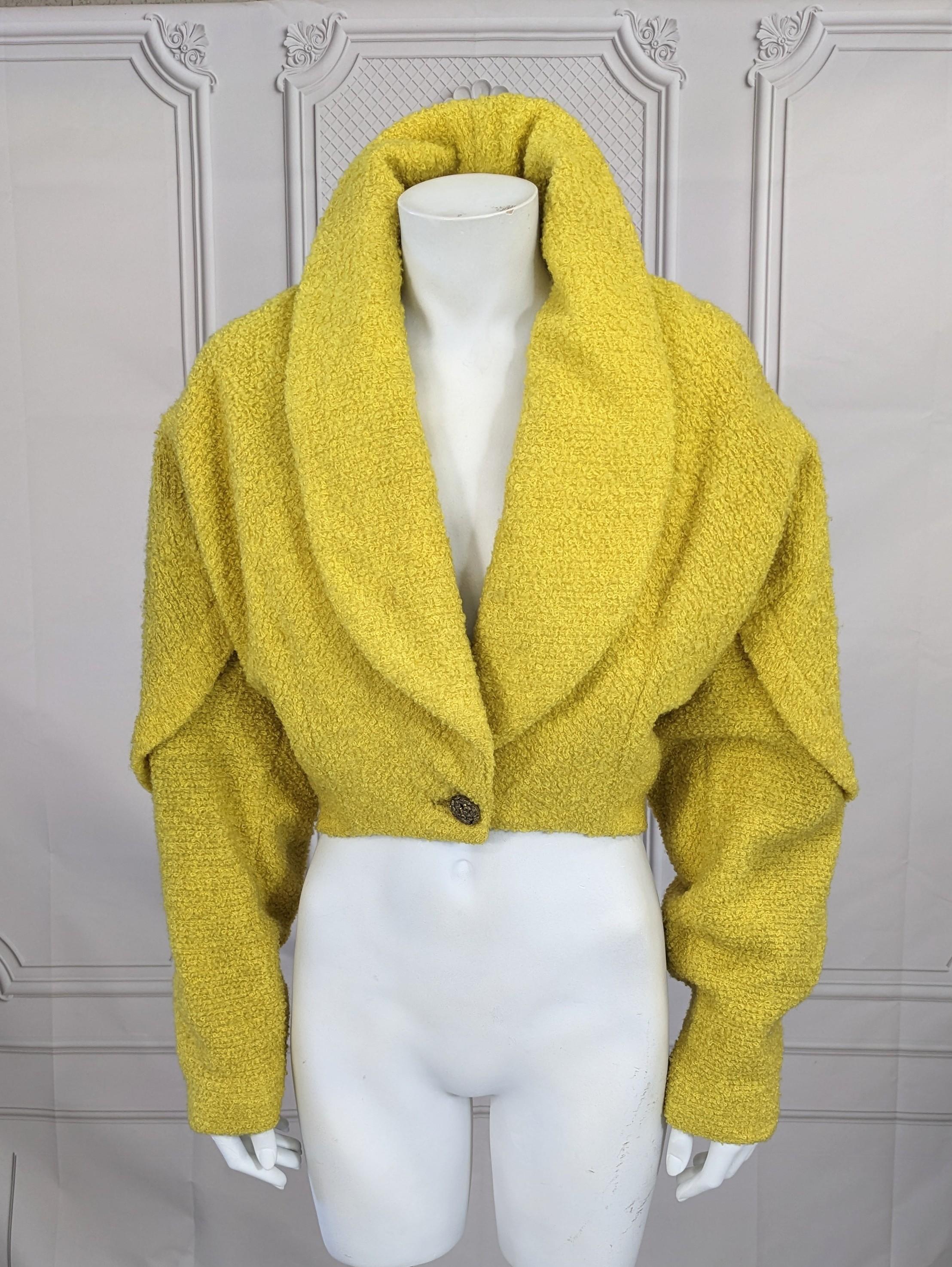 Unusual Chrome Yellow Wool Boucle Bolero Jacket from the 1950's by Ranleigh retailed at I. Magnin, very Alaia in shape. Boucle looped wool in a vibrant punch of color. Full cut through shoulders and bust with tight waist. Faux cape line cut extends