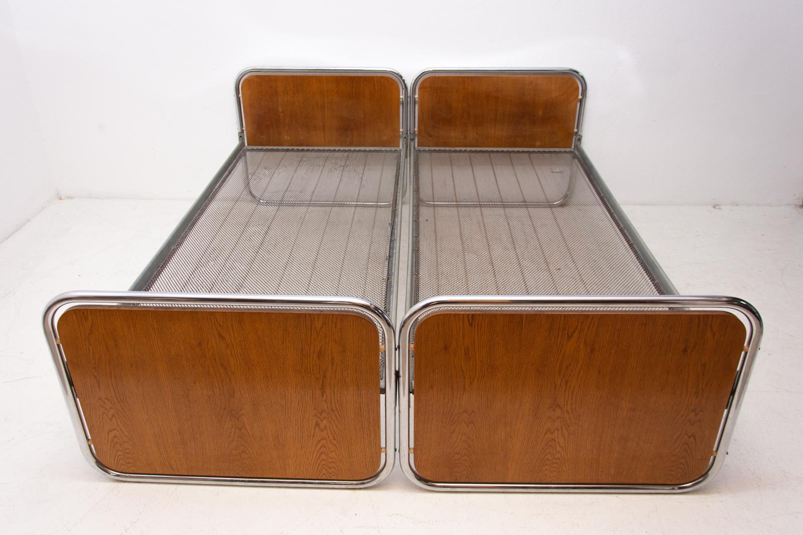 Pair of functionalist chromed beds. Outstanding timeless design. It was produced by Kovona company in the former Czechoslovakia in the 1950s.

It's made of wood and chrome. It's a typical example of Czechoslovak functionalism. Chrome is in very