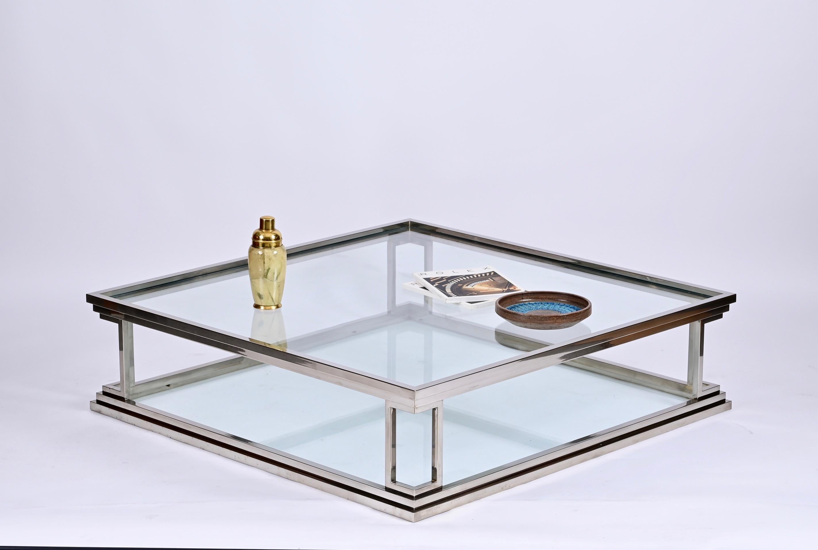 Incredible large-sized coffee table. This fantastic piece was designed in Italy during the 1970s.

This magnificent item is unique because of the luxurious materials, chromed brass with the two glass tops, and the amazing straight and minimal