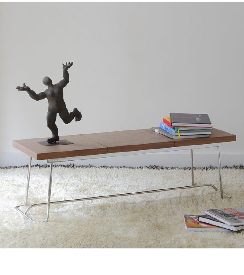 Chromed brera brench by Marcos Zanuso Jr
Materials: Base in bronze lacquered metal or chromed metal Top in walnut veneer on medium or in black lacquered oak on medium
Technique: Lacquered metal, natural or stained wood. 
Dimensions: D 45 x W 130