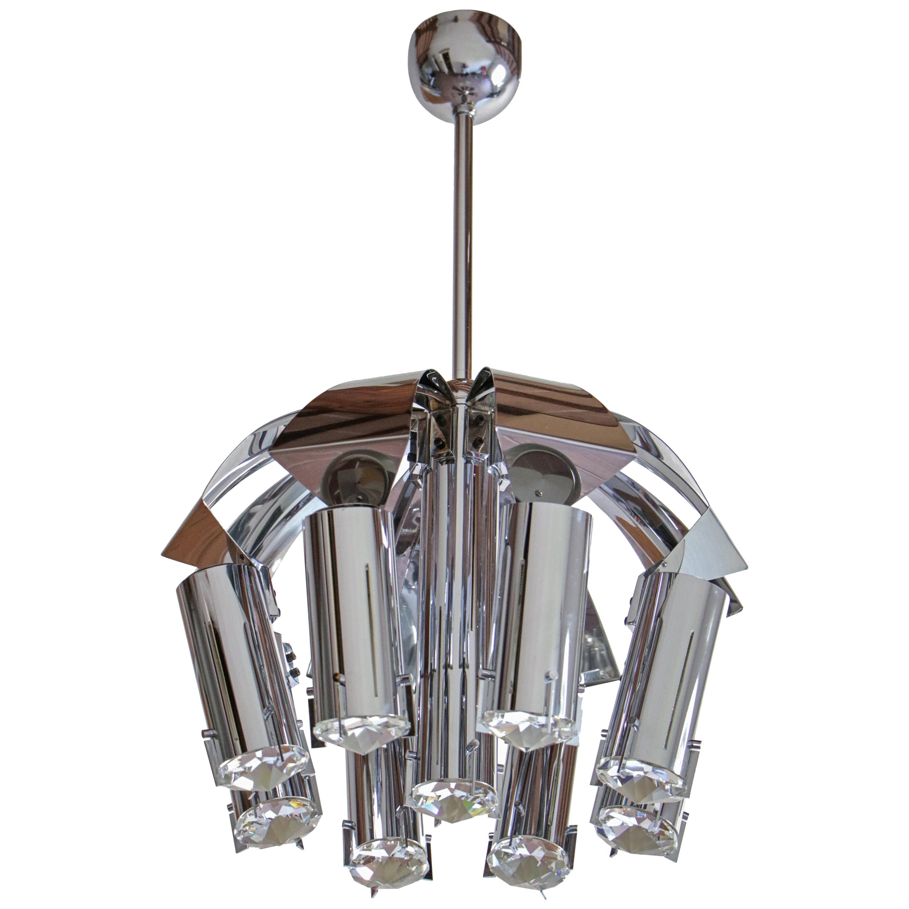 Wonderful chromed chandelier pendant ceiling lamp attributed to Goffredo Reggiani from the '70s. Structure made of chromed brass and crystal. Nine functional lights, E14 format. Unique design and prestigious executive quality are the characteristics