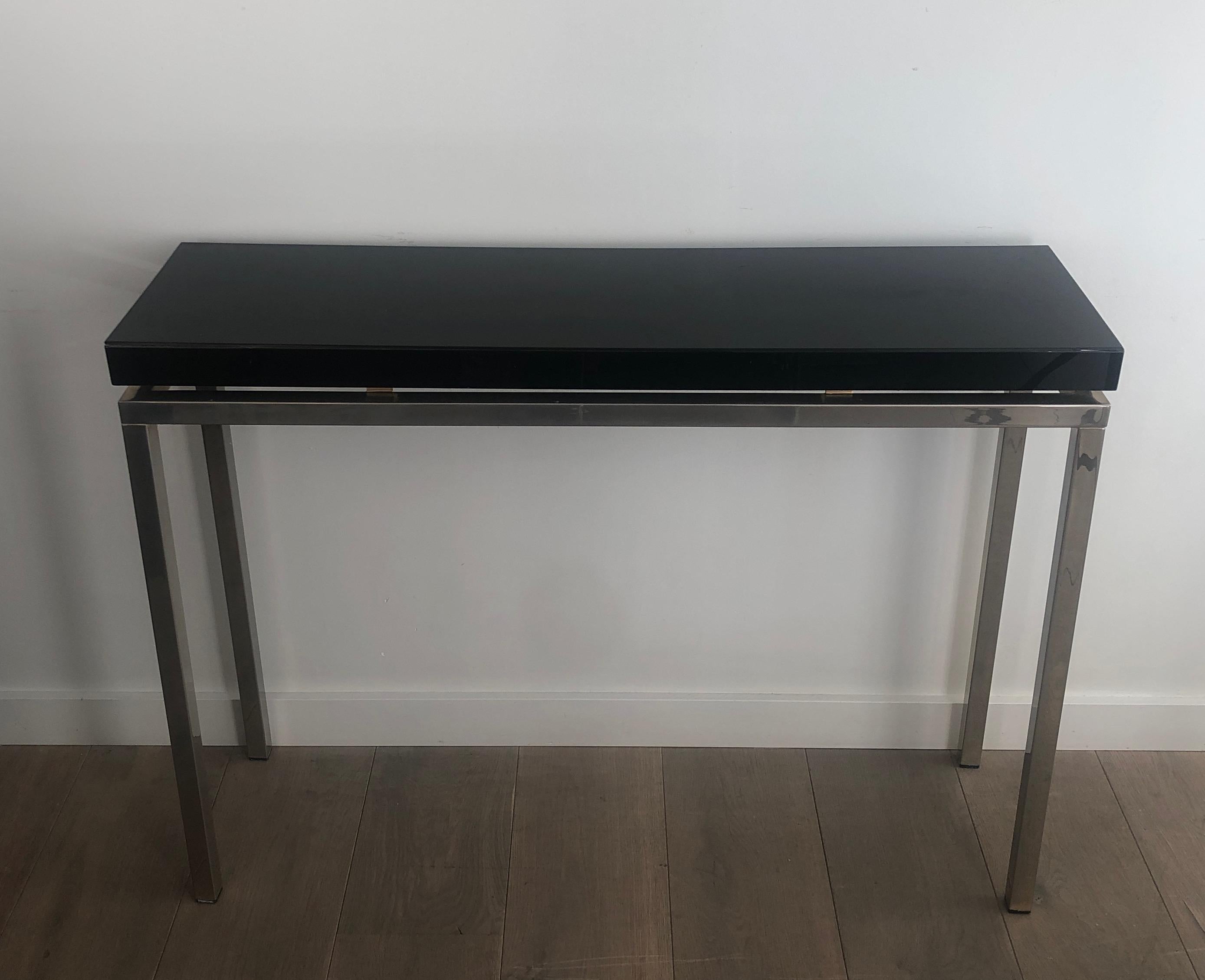 This nice and elegant console table is made of Chromed with a thick black lacquered top. This is a French work. Circa 1970