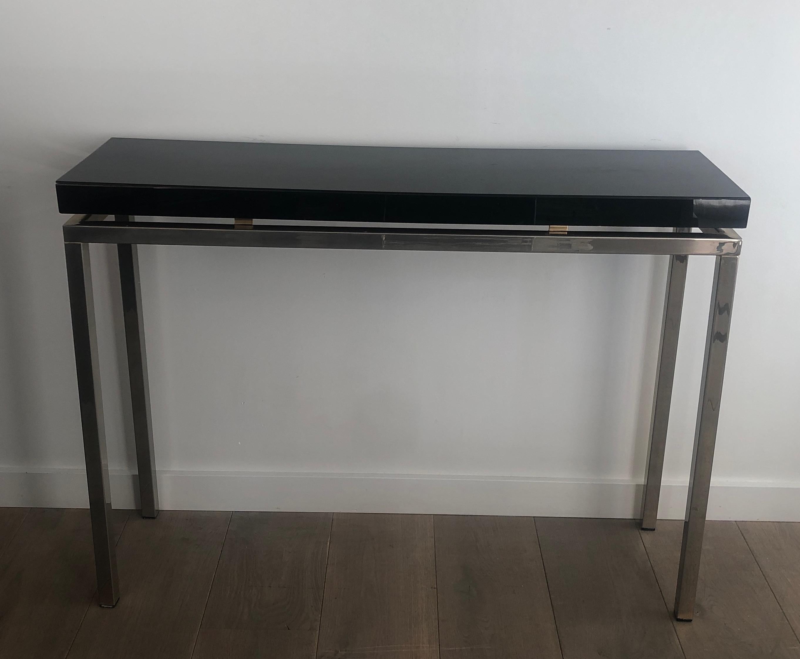 Mid-Century Modern Chromed console with thick black lacquered top. French work. Circa 1970 For Sale