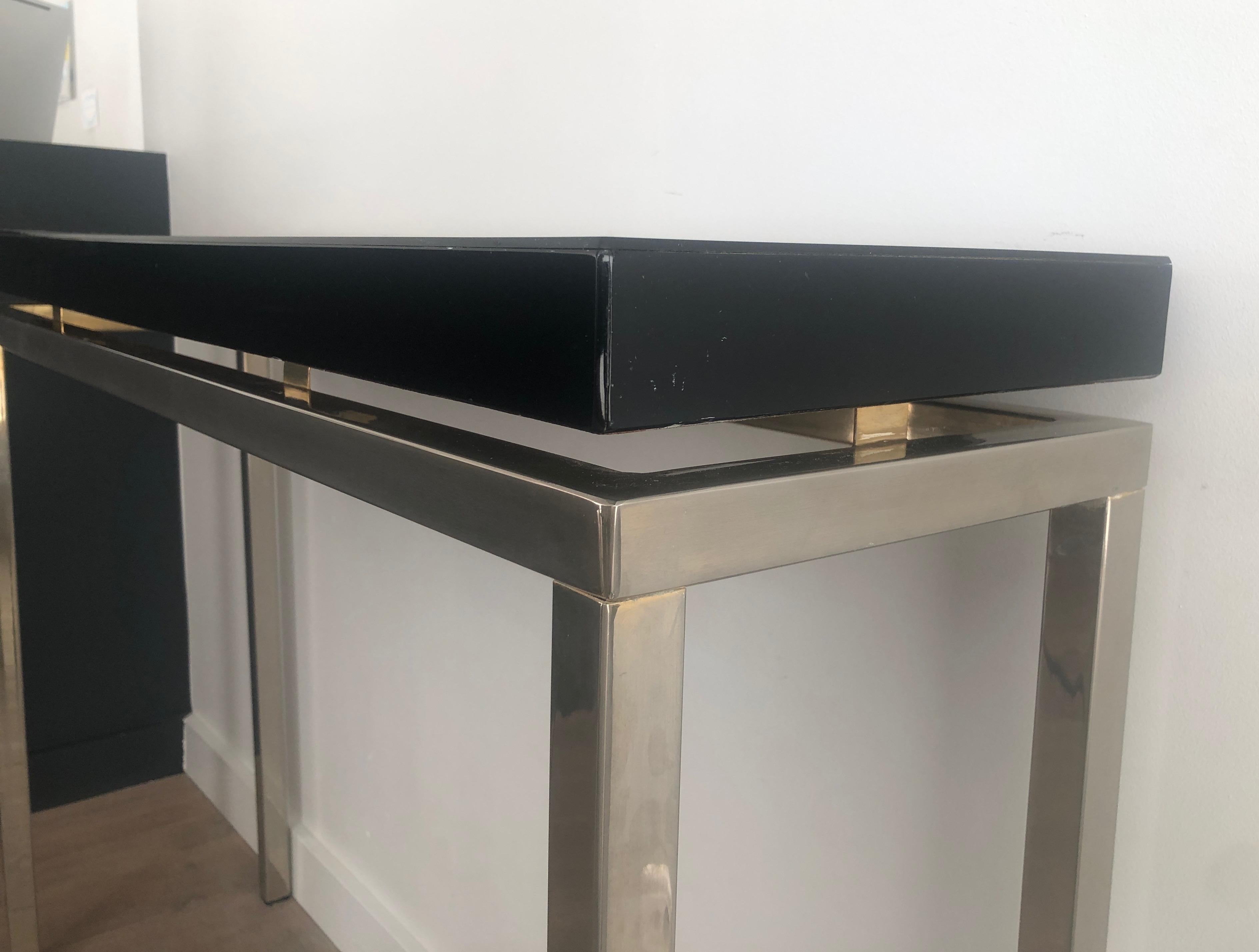 Lacquered Chromed console with thick black lacquered top. French work. Circa 1970 For Sale
