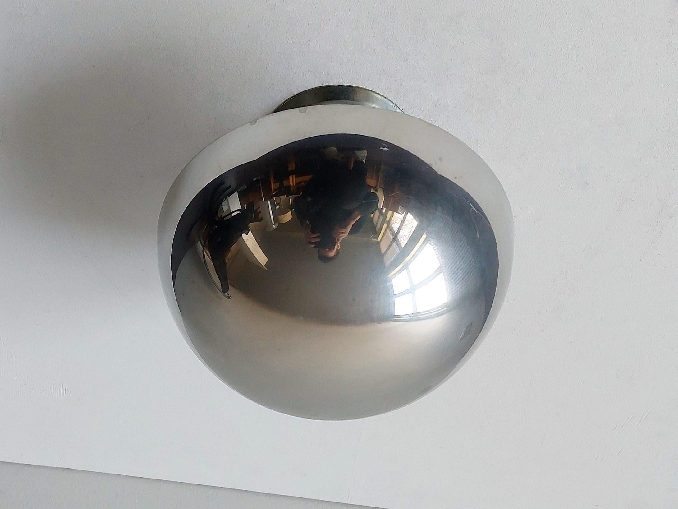 This ceiling lamp was designed by Verner Panton for Louis Poulsen in the 1960's. It is clearly part of the 'Flowerpot familiy'. It is a playful piece with a mirrored chrome outside and a soft pink inside that gives a very decorative and warm