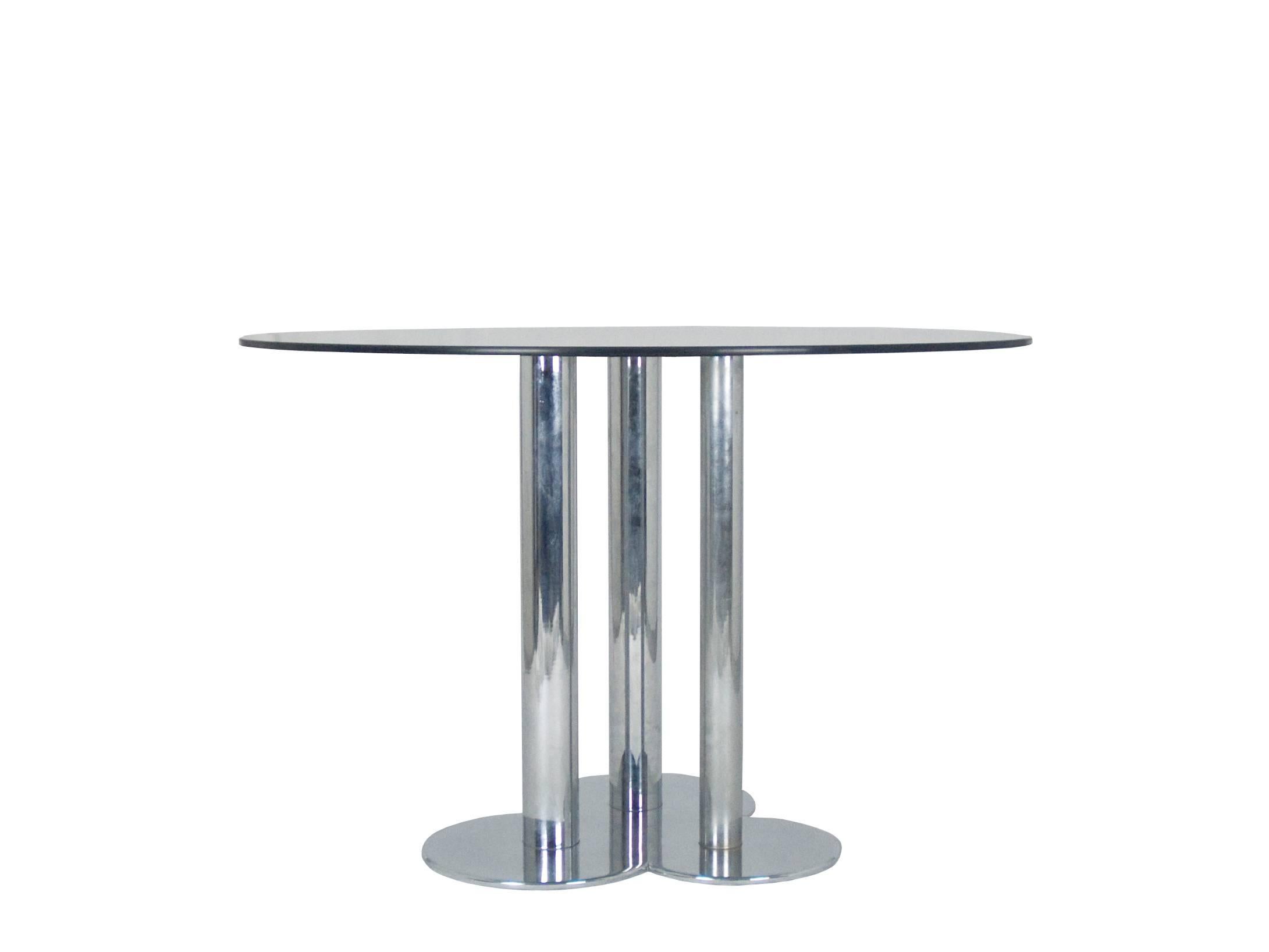 This table was produced in Italy by Poltronova in 1969. It is made from a chrome plated base with a shaped thick feet and a black skai top cover, it features a round smoke glass top. Very good vintage condition: few light skai defects as stated in