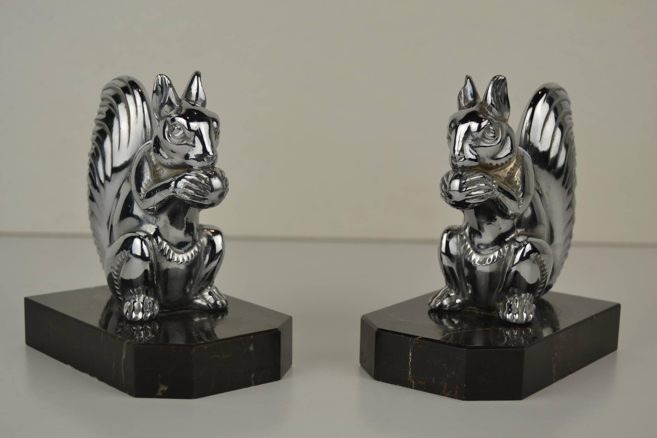 Stylish set of Art Deco bookends with chromed squirrels.
These cute chromed squirrels are mounted on marble mases.
They have a modern look-modern style. 

Animal figurine, animal sculpture, animal bookends, squirrels,
Art Deco bookends.