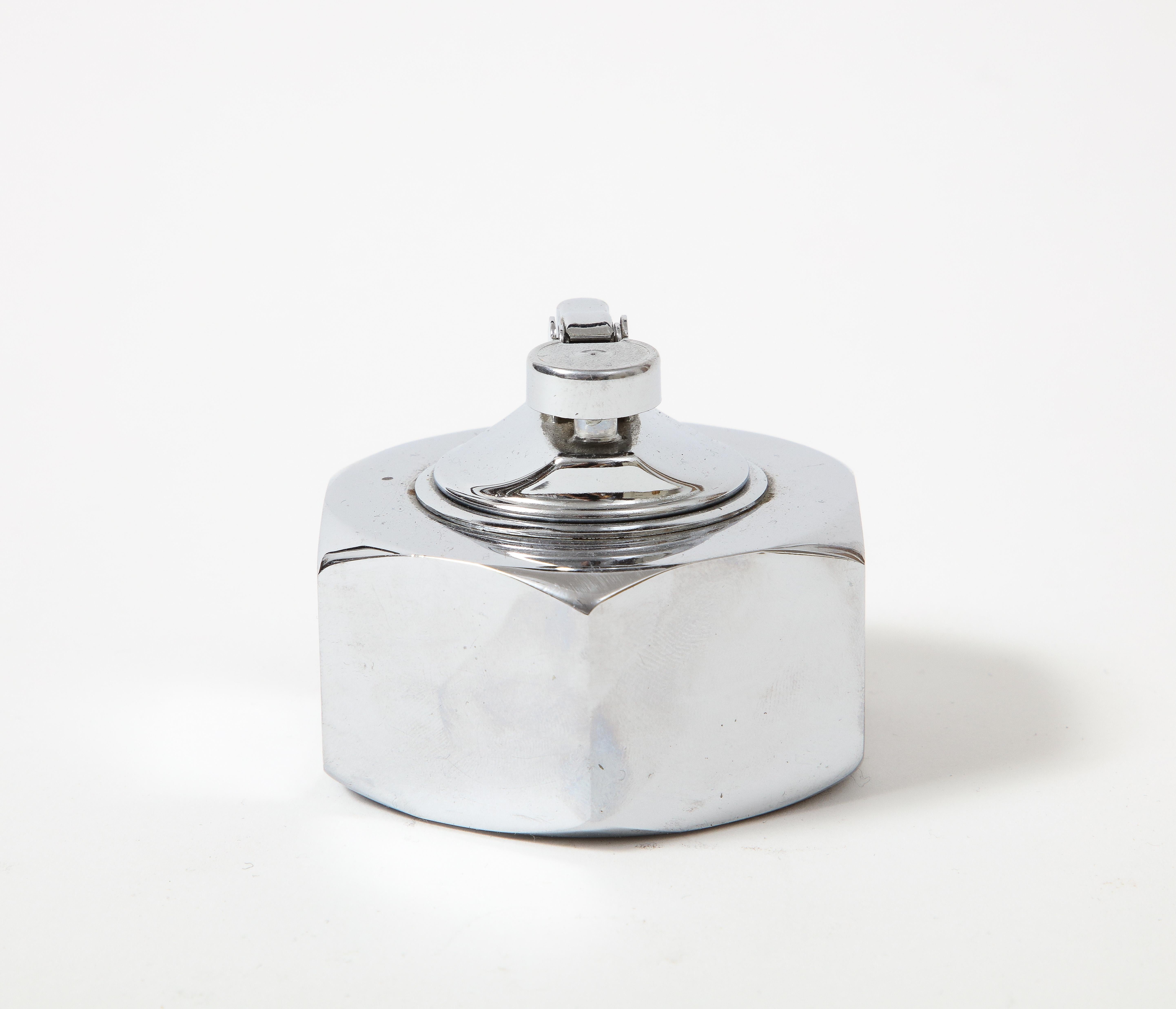 Chromed, polished table lighter in the shape of a bolt. 