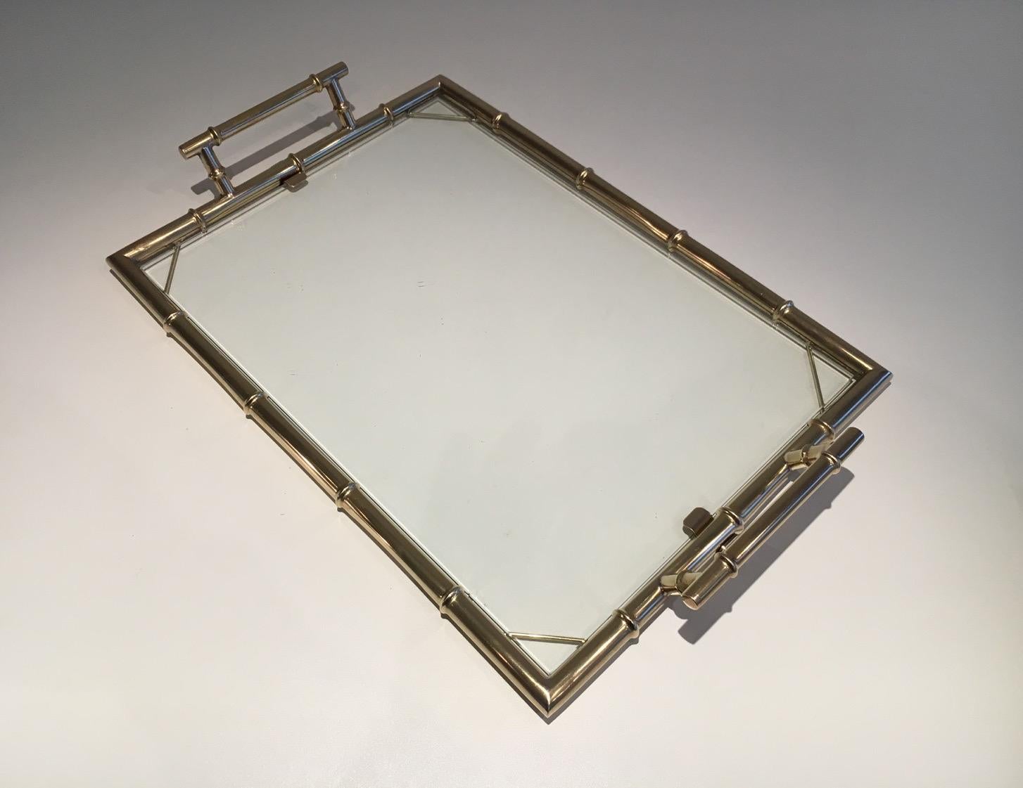 This faux-bamboo style tray is made of chrome with a piece of glass. This is a French design, circa 1970.