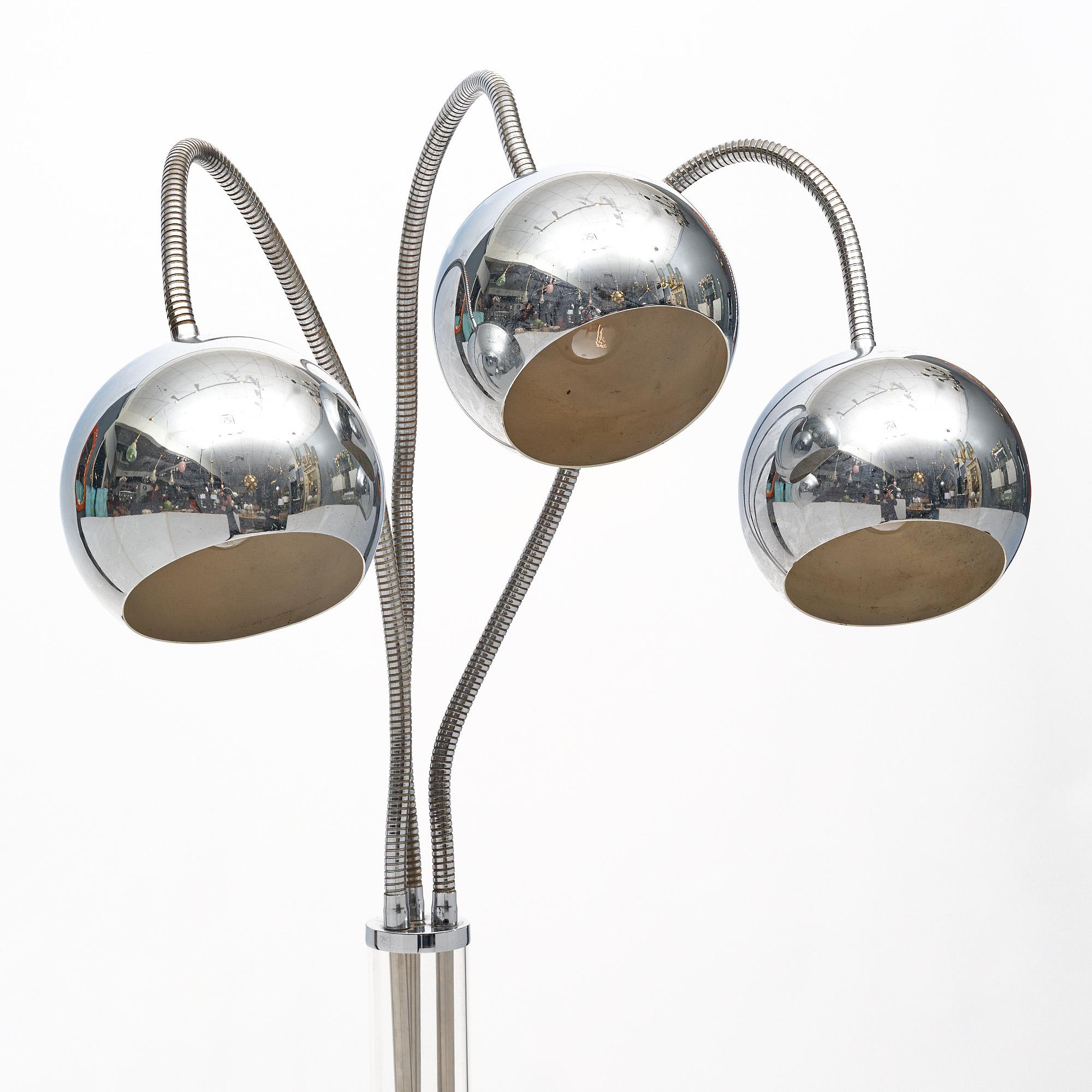Floor lamp from mid-century Italy with three chromed adjustable arms. Each arm features the original shade. The body of the lamp is Lucite. It has been newly wired to fit US standards. The height listed of 79