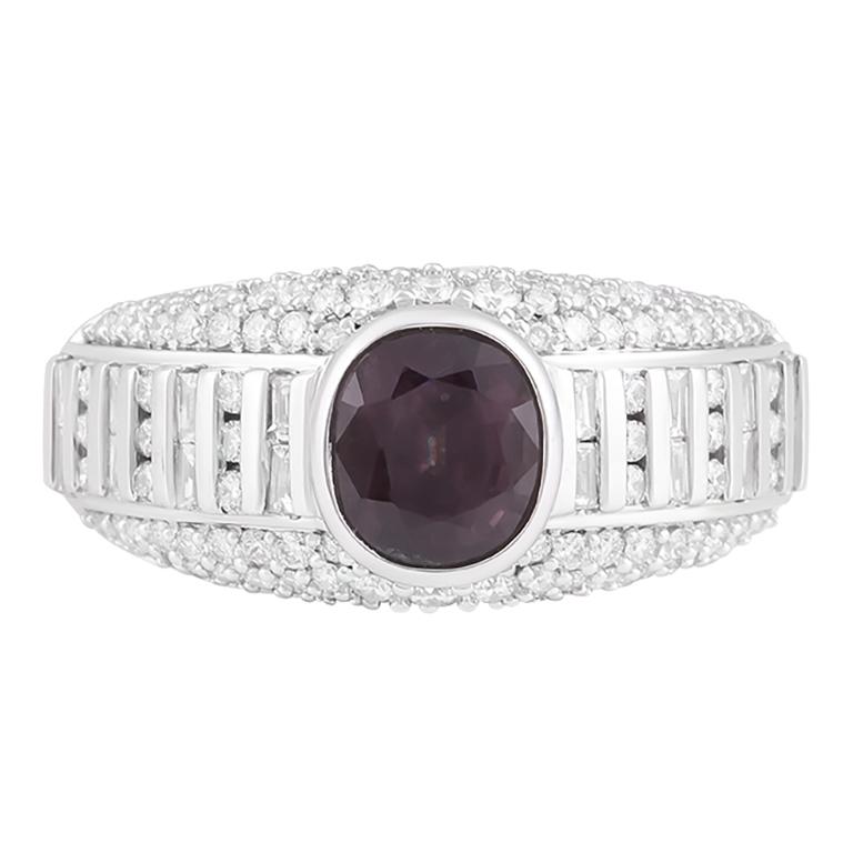 Celebrate the wonders of nature’s artistry with this Color Change Garnet & Diamond Ring, an enchanting creation that captivates with its rare beauty. At the heart of this design lies a 2.54-carat color change garnet, a gemstone prized for its