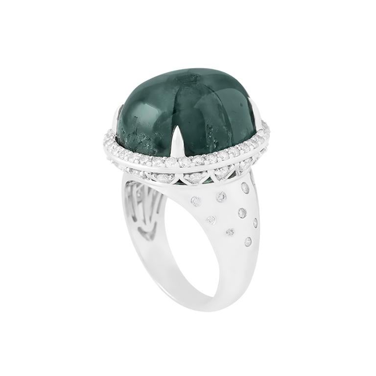 Rare and undeniably captivating, this 24.98ct Emerald Trapiche ring is a bold statement of nature’s artistry and fine craftsmanship. Set in luminous 18K white gold, the centerpiece features a large, oval-cut Trapiche emerald, prized for its striking