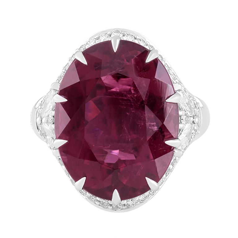 Radiant and powerful, this Rubellite & Diamond Ring is a true masterpiece of refined artistry. At its center rests an extraordinary 18.65-carat rubellite, glowing with a deep, vivid raspberry-red hue. Known for its rarity and captivating energy, the