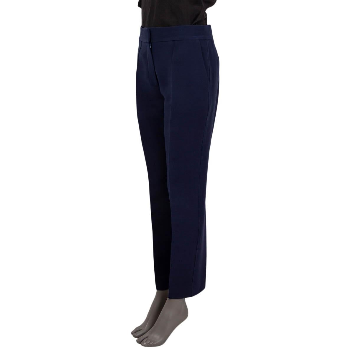 100% authentic Christian Dior suit pants in navy blue wool (77%) and silk (23%). Features two two slit pockets on the front and two slit pockets on the back. Open with a concealed hook, button and zipper on the front. Unlined. Have some dark stains