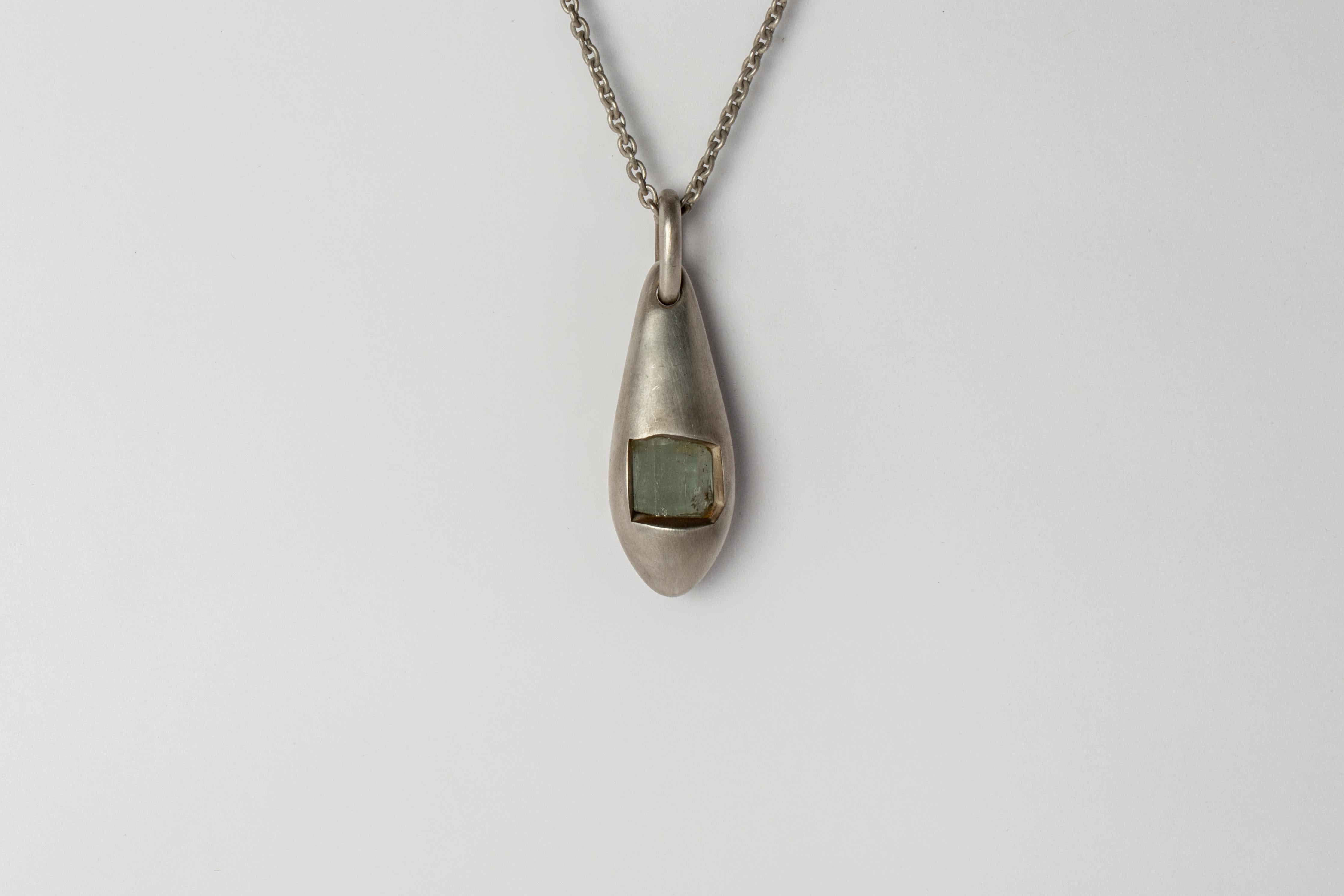 Pendant necklace in the shape of a chrysalis in sterling silver and a slab of rough aquamarine. It comes on a 74cm chain. Each piece is unique and this is what makes it special. 
