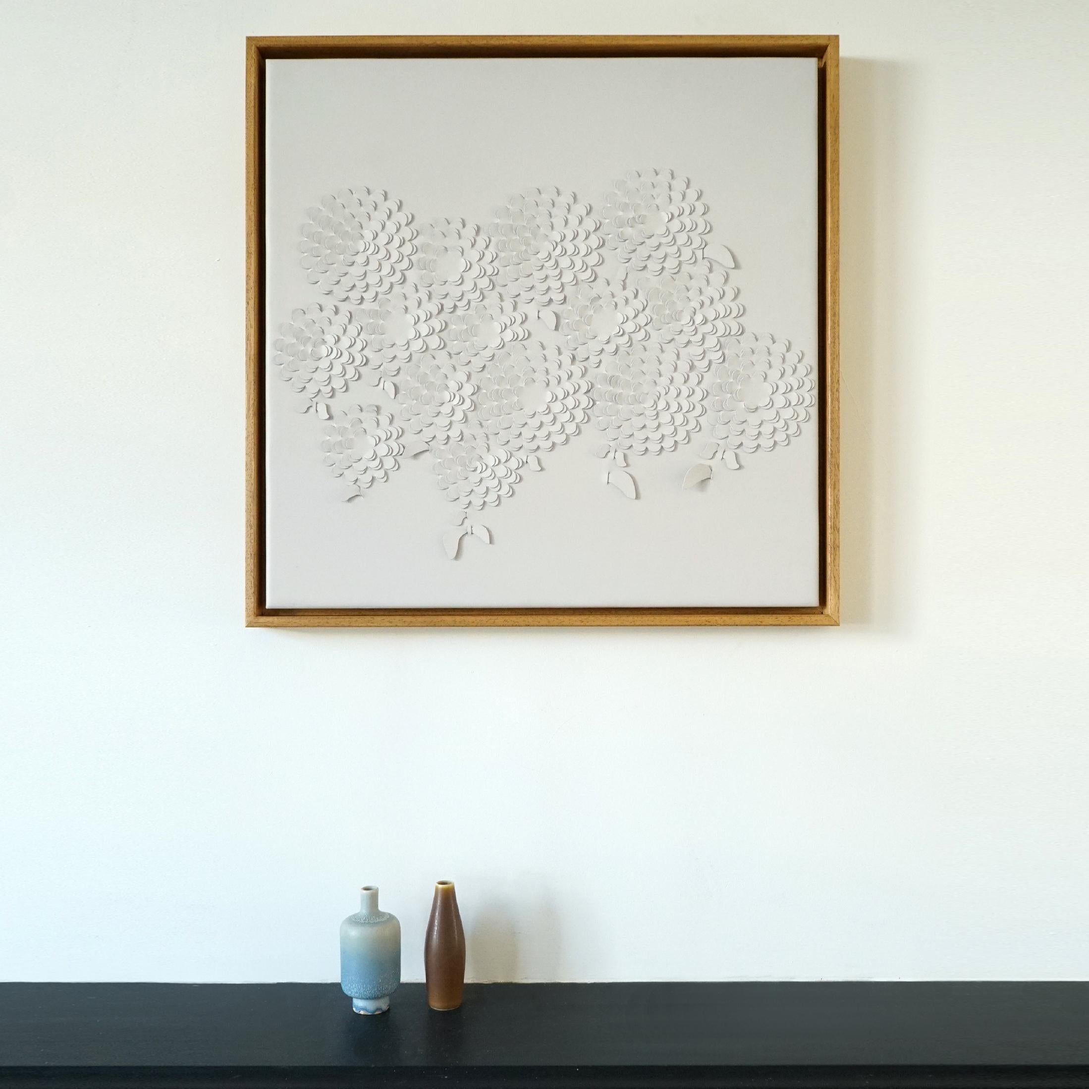Chrysanthemum:

A piece of 3D sculptural wall art designed and made from two layers of cream leather, woven together by Louise Heighes.
Measurements are 25.5 x 25.5 inches or 65 x 65 cm

This piece is inspired by the big mass of repeating petals of